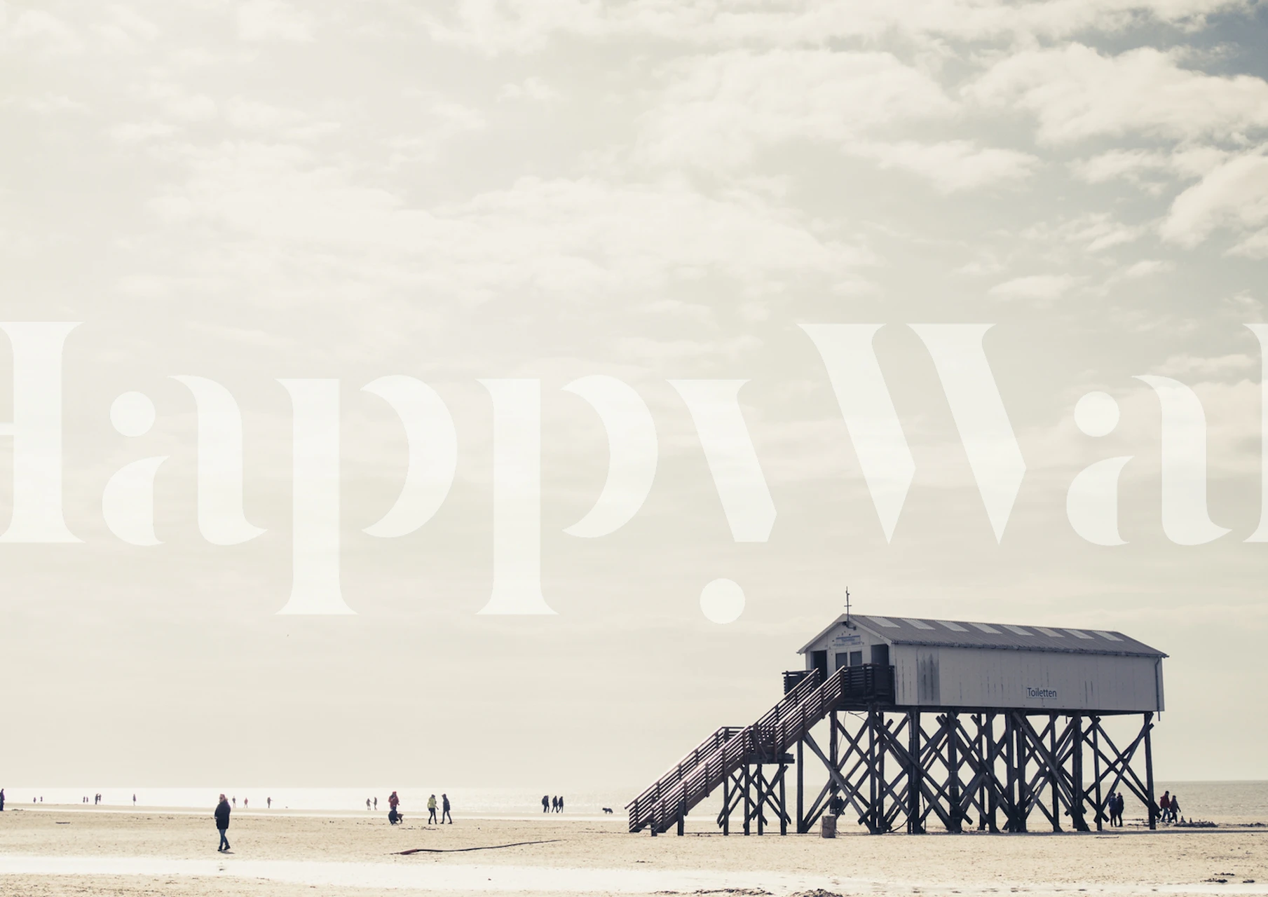 Fotomural vinílico de parede sereno com cena de praia com casa de praia e figuras distantes