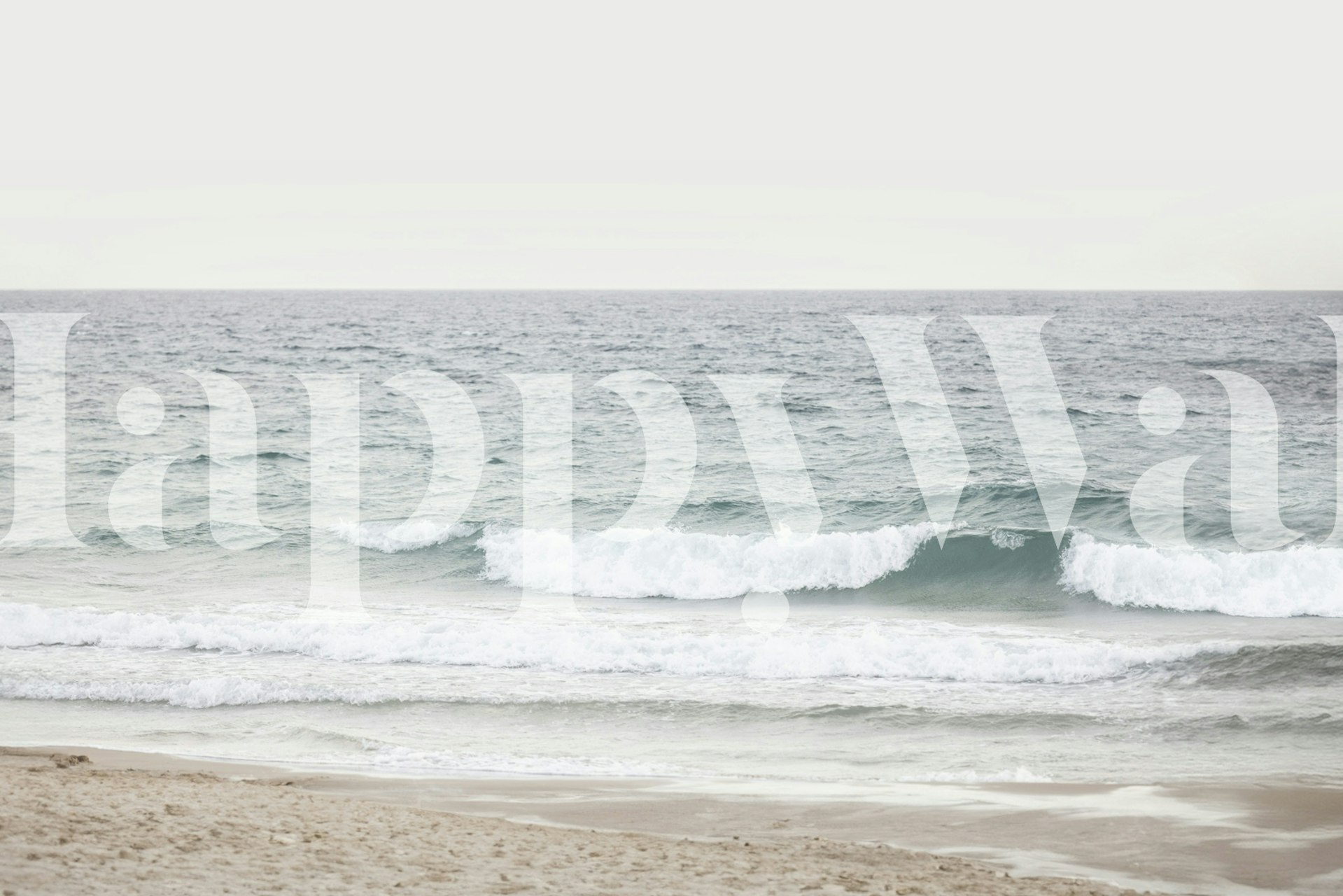 Ocean waves on a beach with soft beige sand and blue water wallpaper