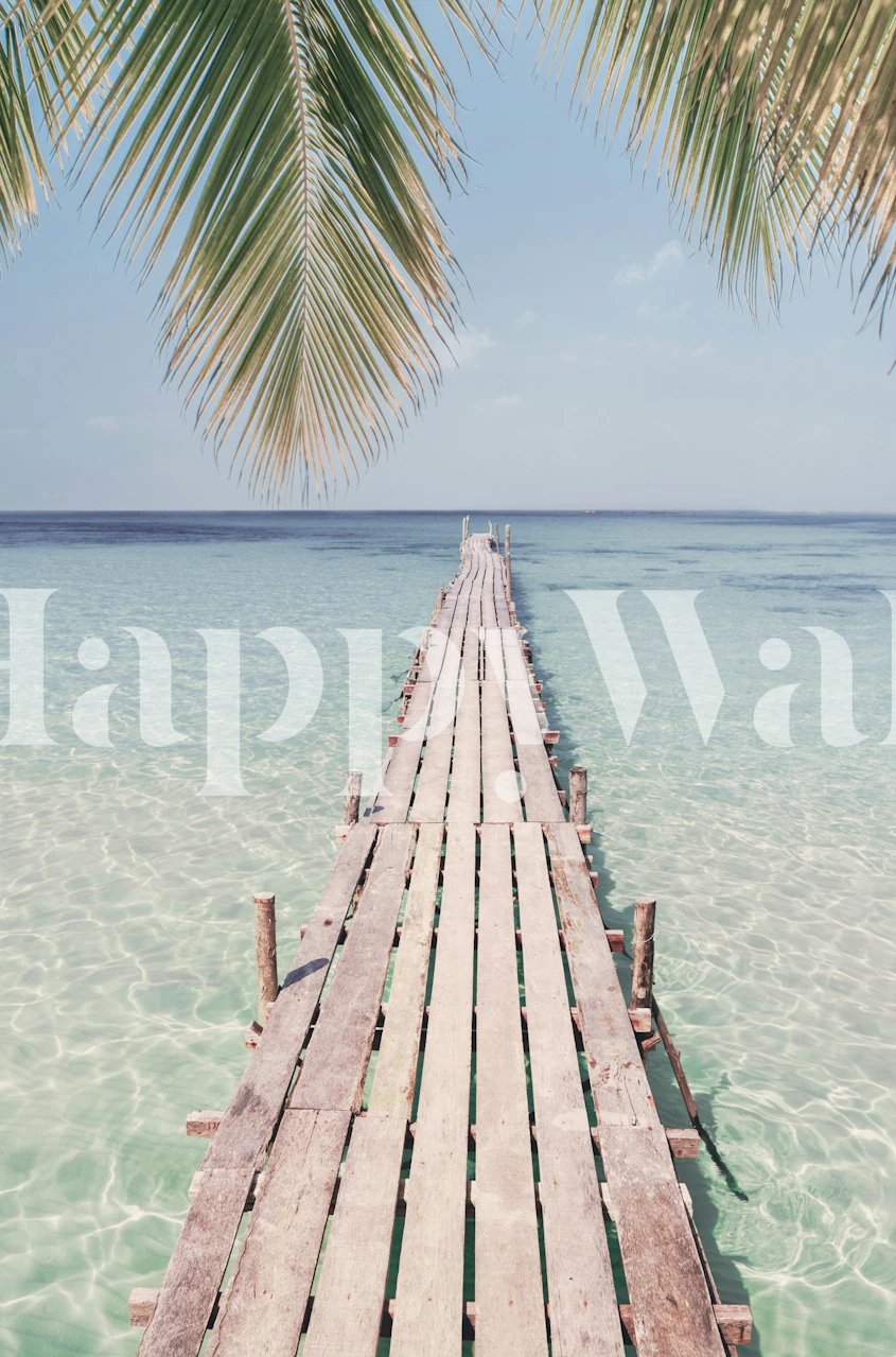 Wooden pier extending into clear water with palm trees wallpaper
