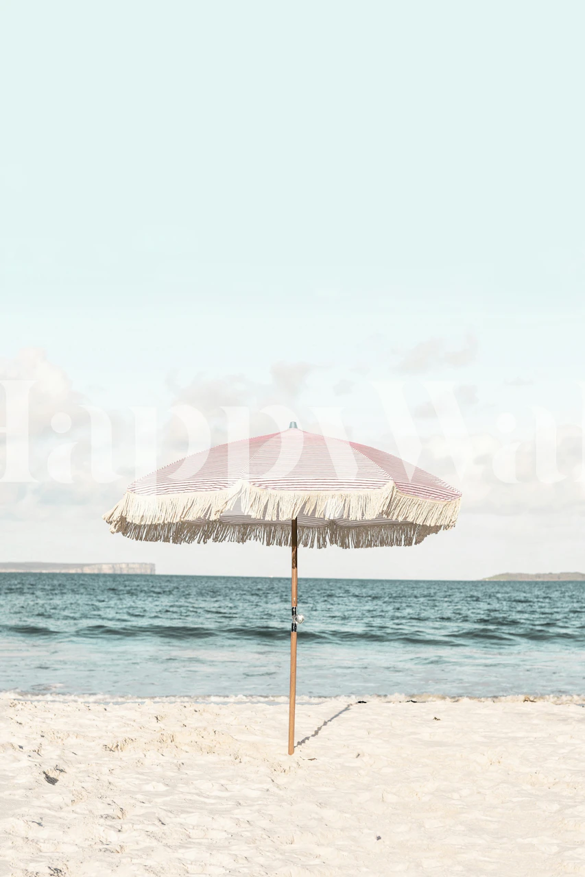 Pink striped umbrella with fringe on a beach wallpaper