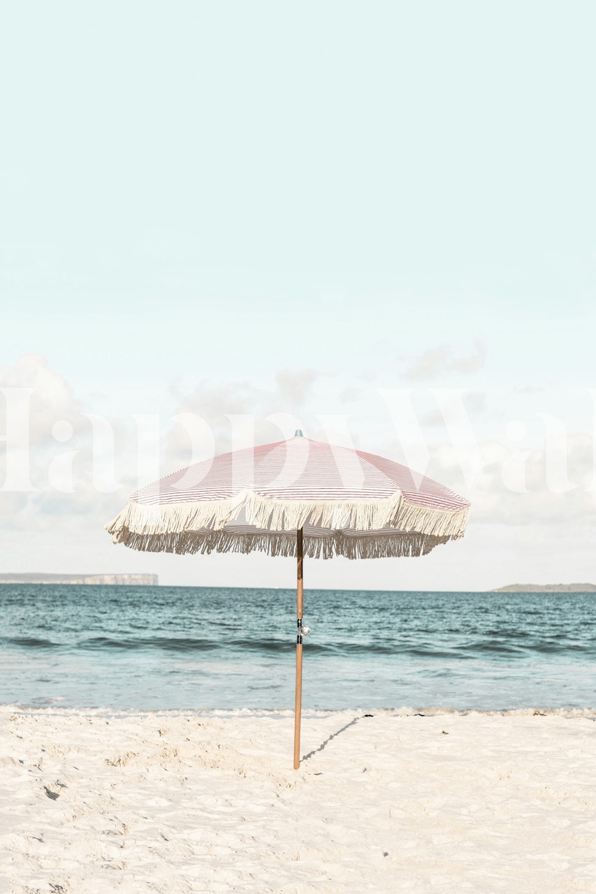 Pink striped umbrella with fringe on a beach wallpaper