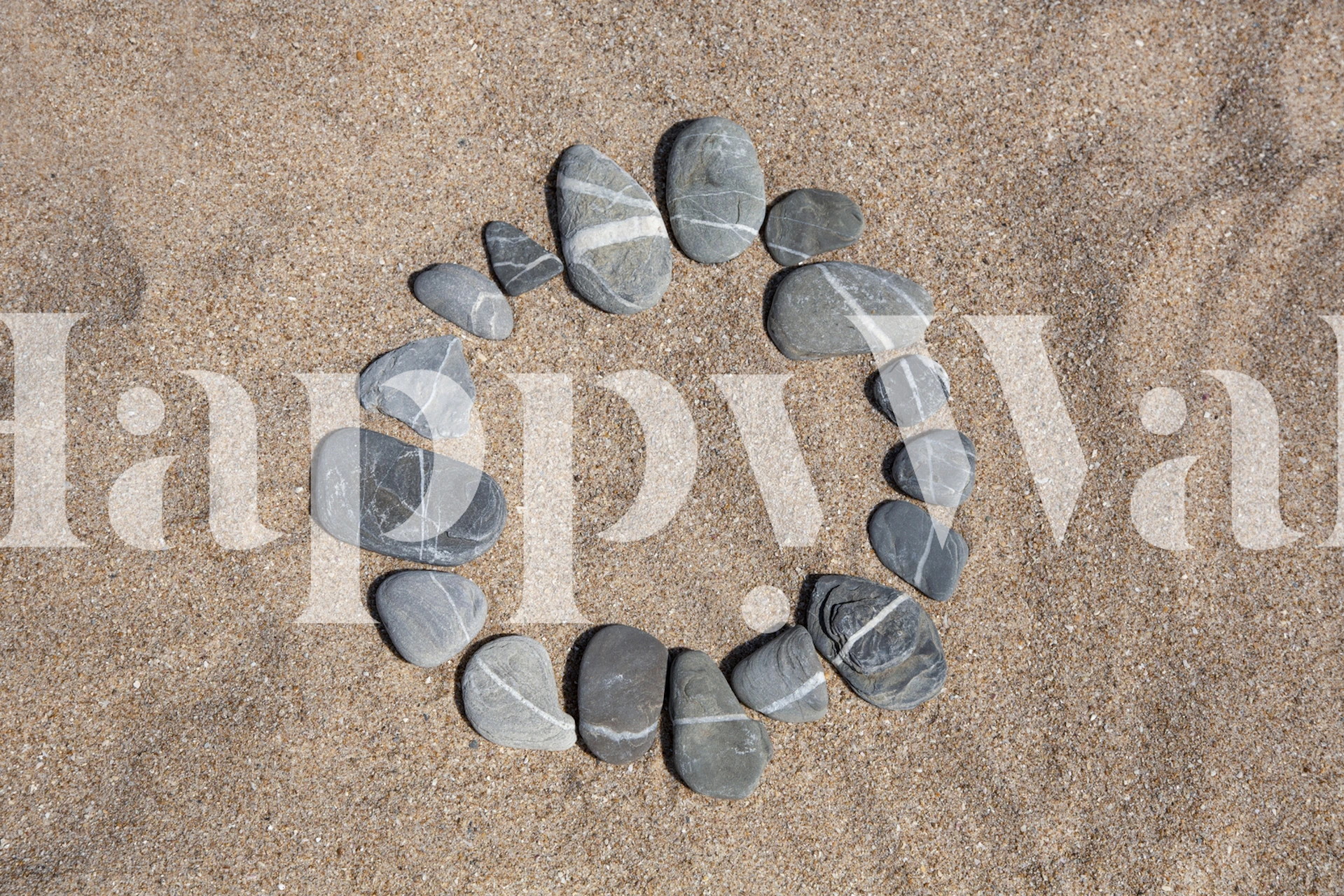Grey pebble circle on sandy background wallpaper