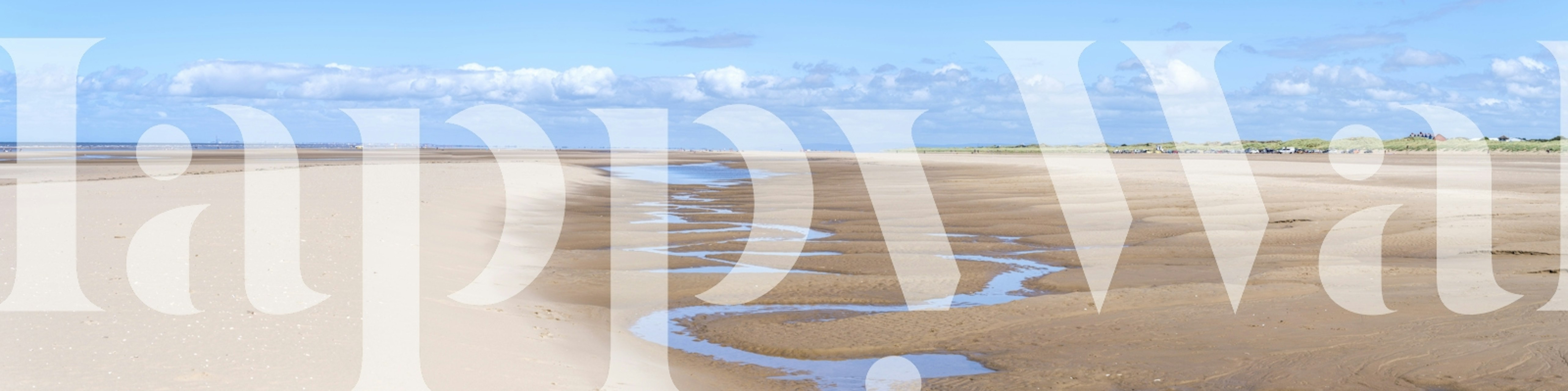 Coastal beach scene wallpaper with blue sky and sandy shore