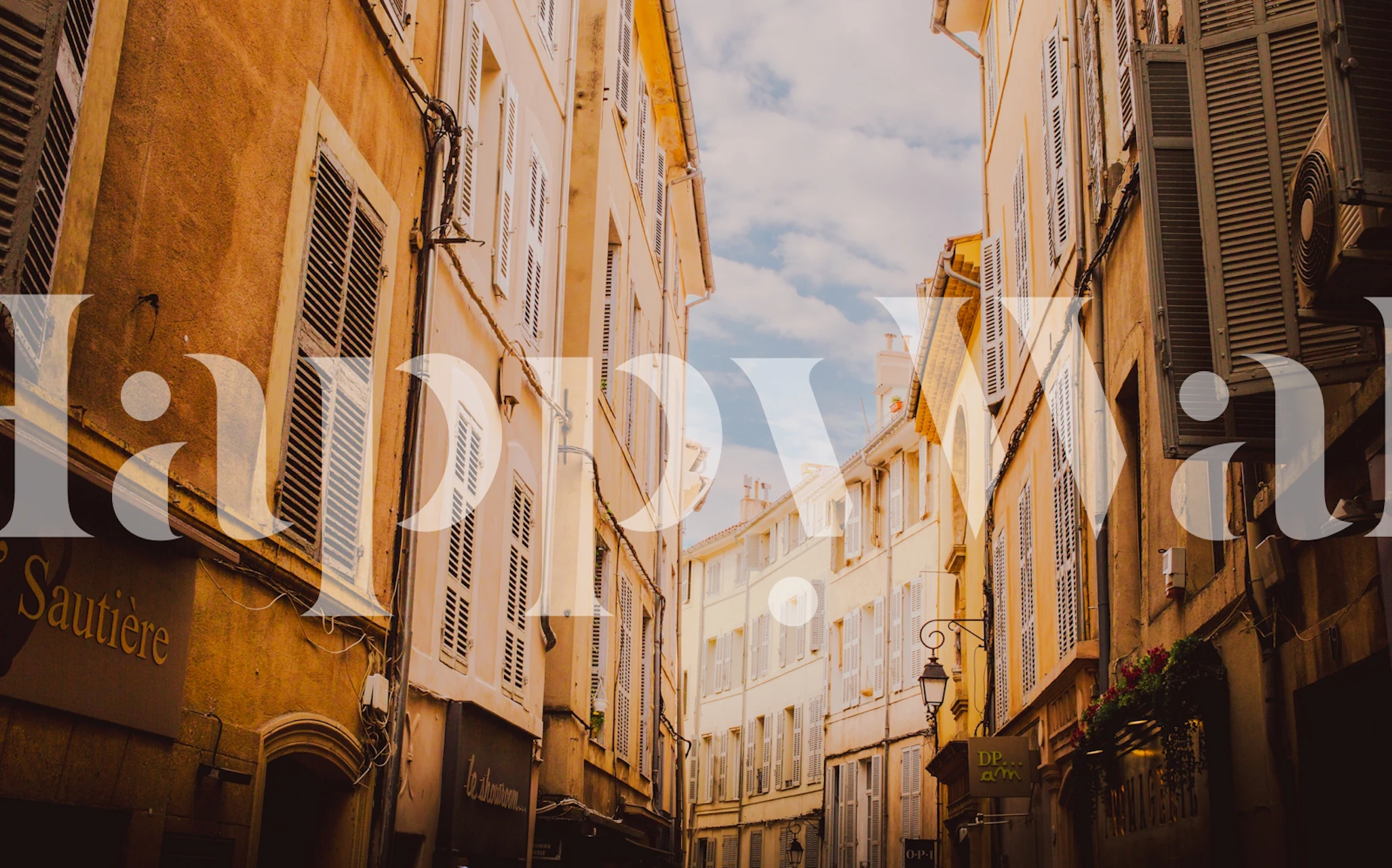 Narrow street with old town buildings in warm colors wallpaper