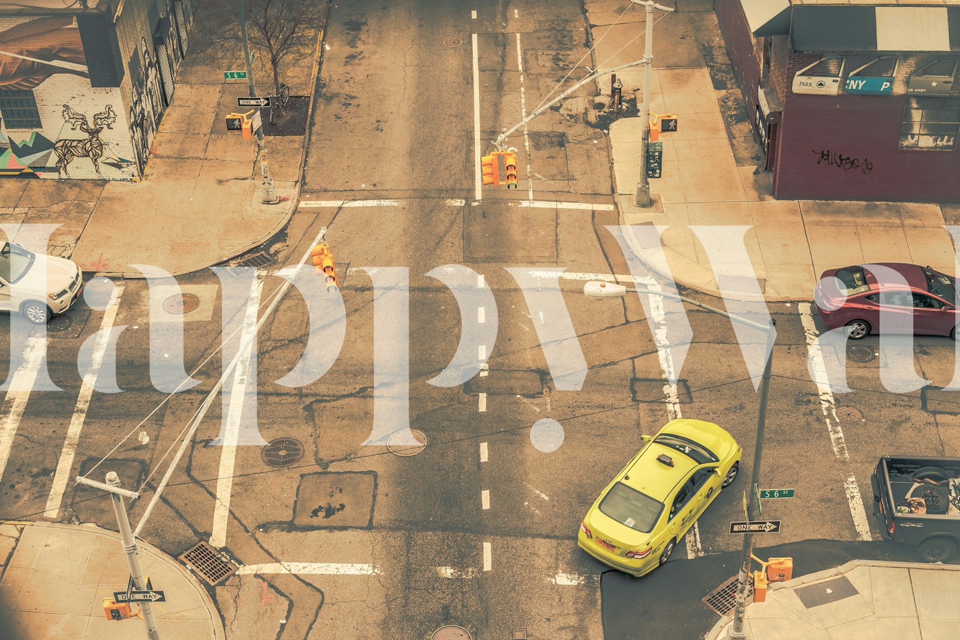 Urban street scene with yellow taxi, crosswalks, and buildings wallpaper