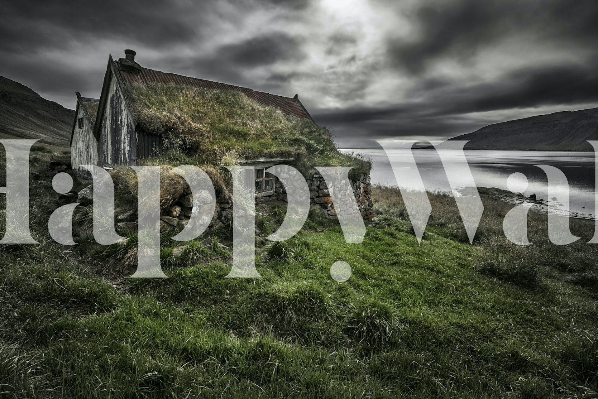 Rugged grass and stone landscape with a rustic house wallpaper