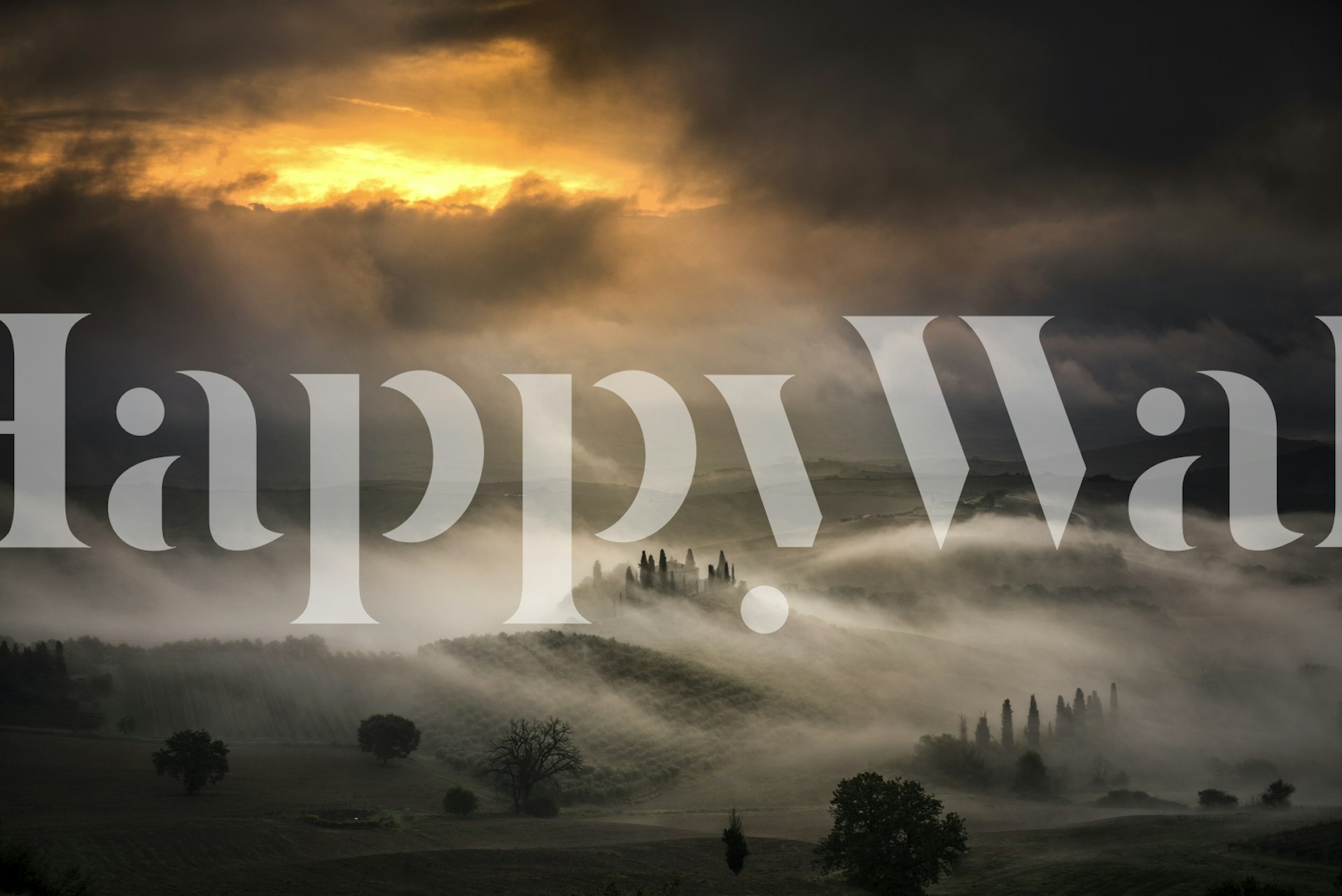 Foggy landscape with rolling hills and dark clouds wallpaper