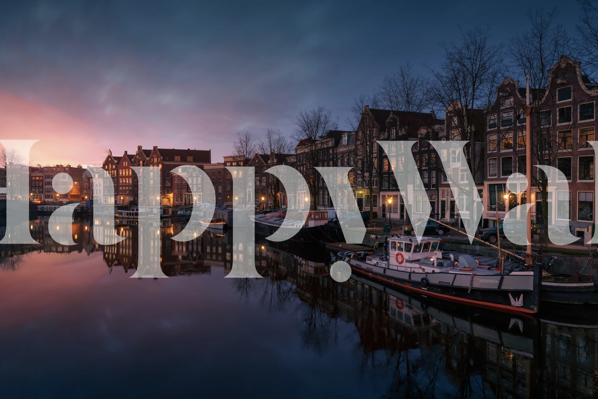 Amsterdam canal at sunset with colorful buildings wallpaper