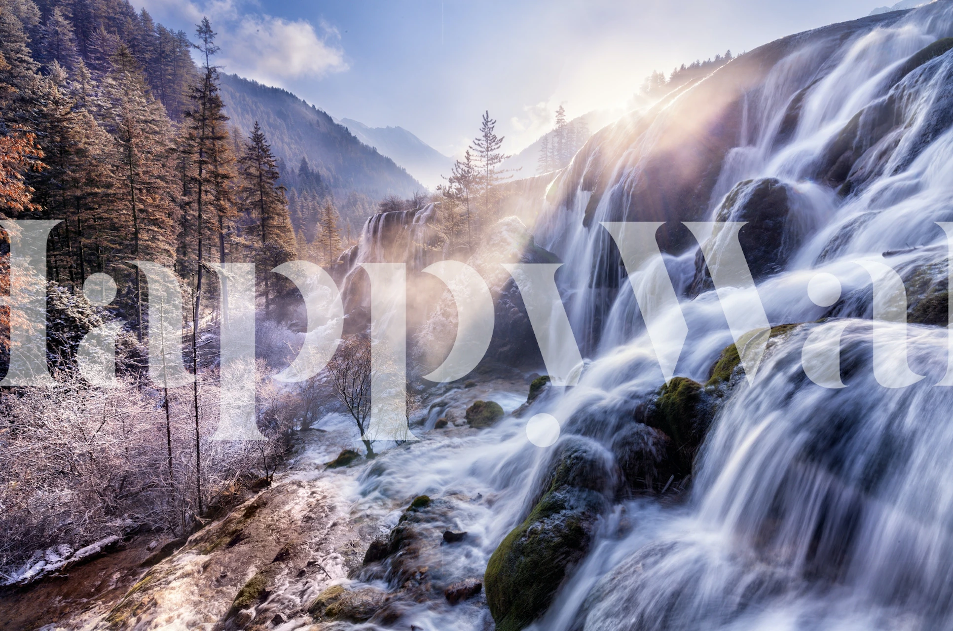 A scenic waterfall surrounded by trees and mountains, natural colors wallpaper