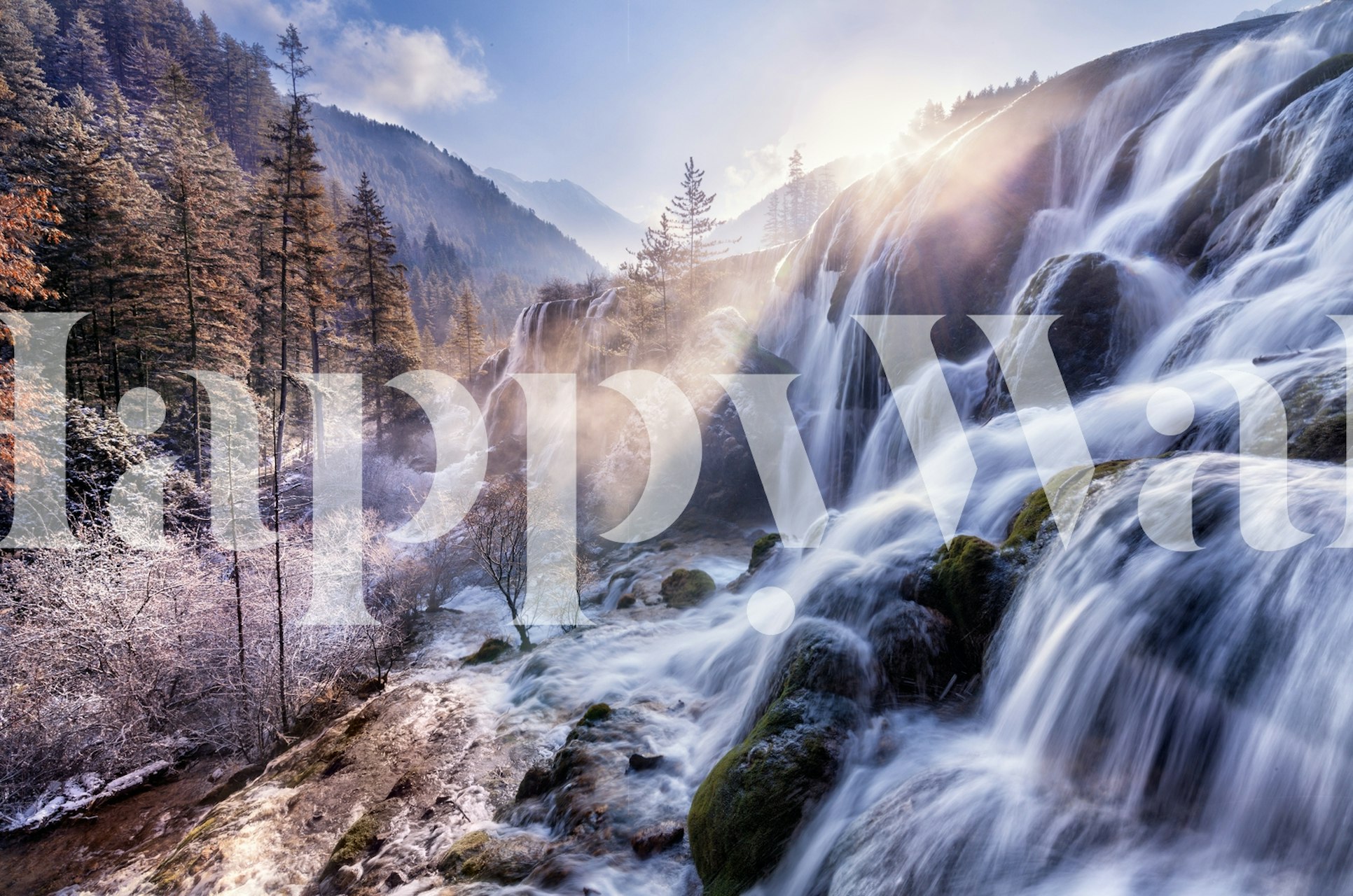 A scenic waterfall surrounded by trees and mountains, natural colors wallpaper