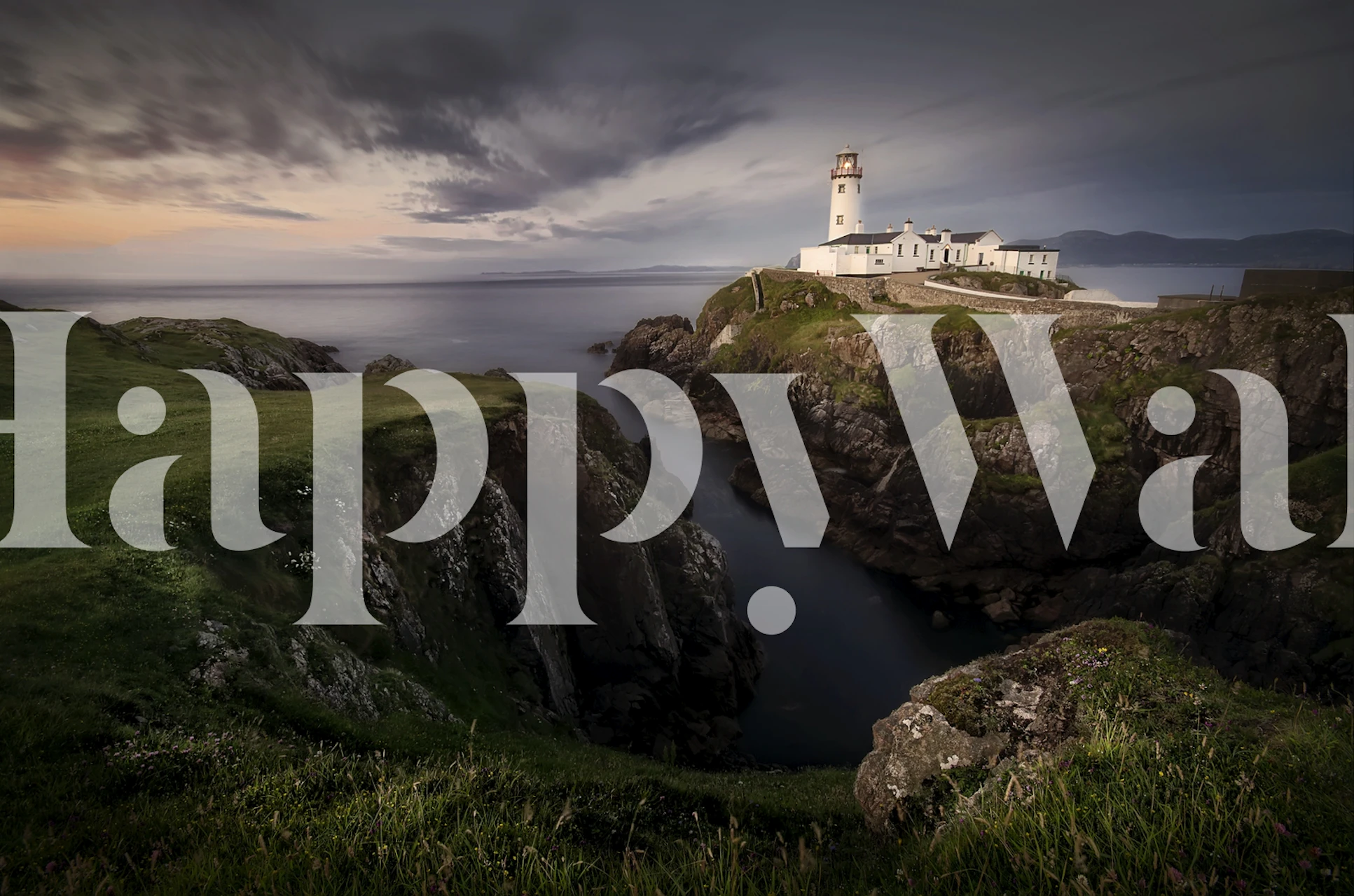 Coastal landscape with lighthouse on rocky cliffs wallpaper