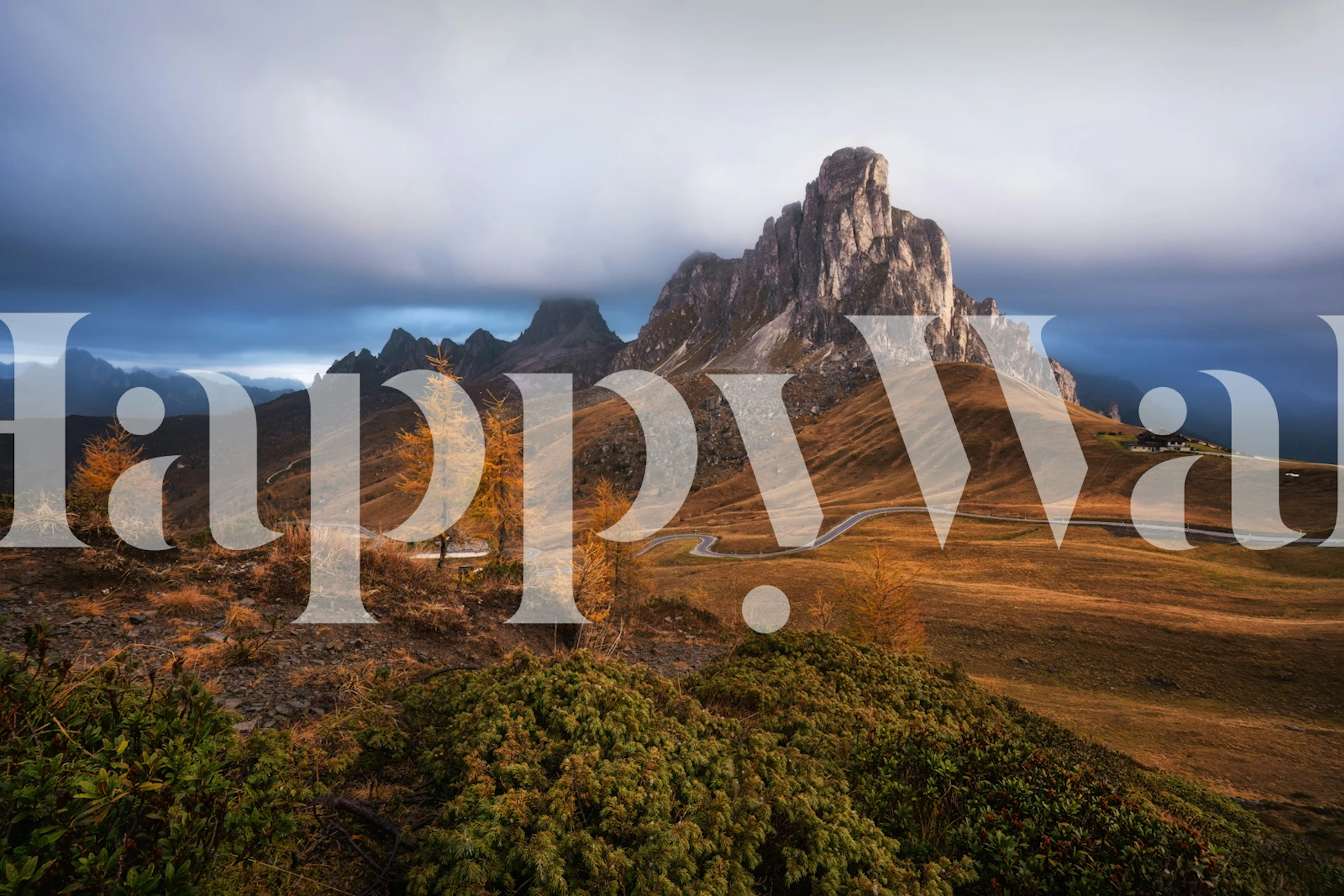 Mountain landscape with golden autumn trees and dark clouds wallpaper
