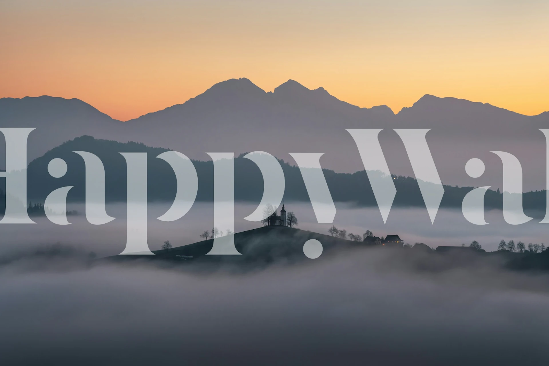 Misty mountain scenery with sunrise, soft blue and orange tones wallpaper
