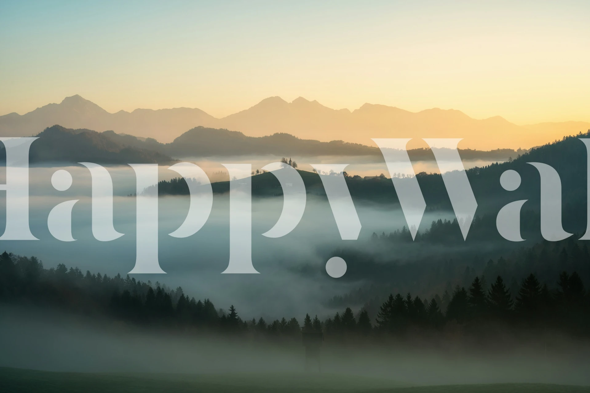 Misty mountain landscape fading into morning light wallpaper