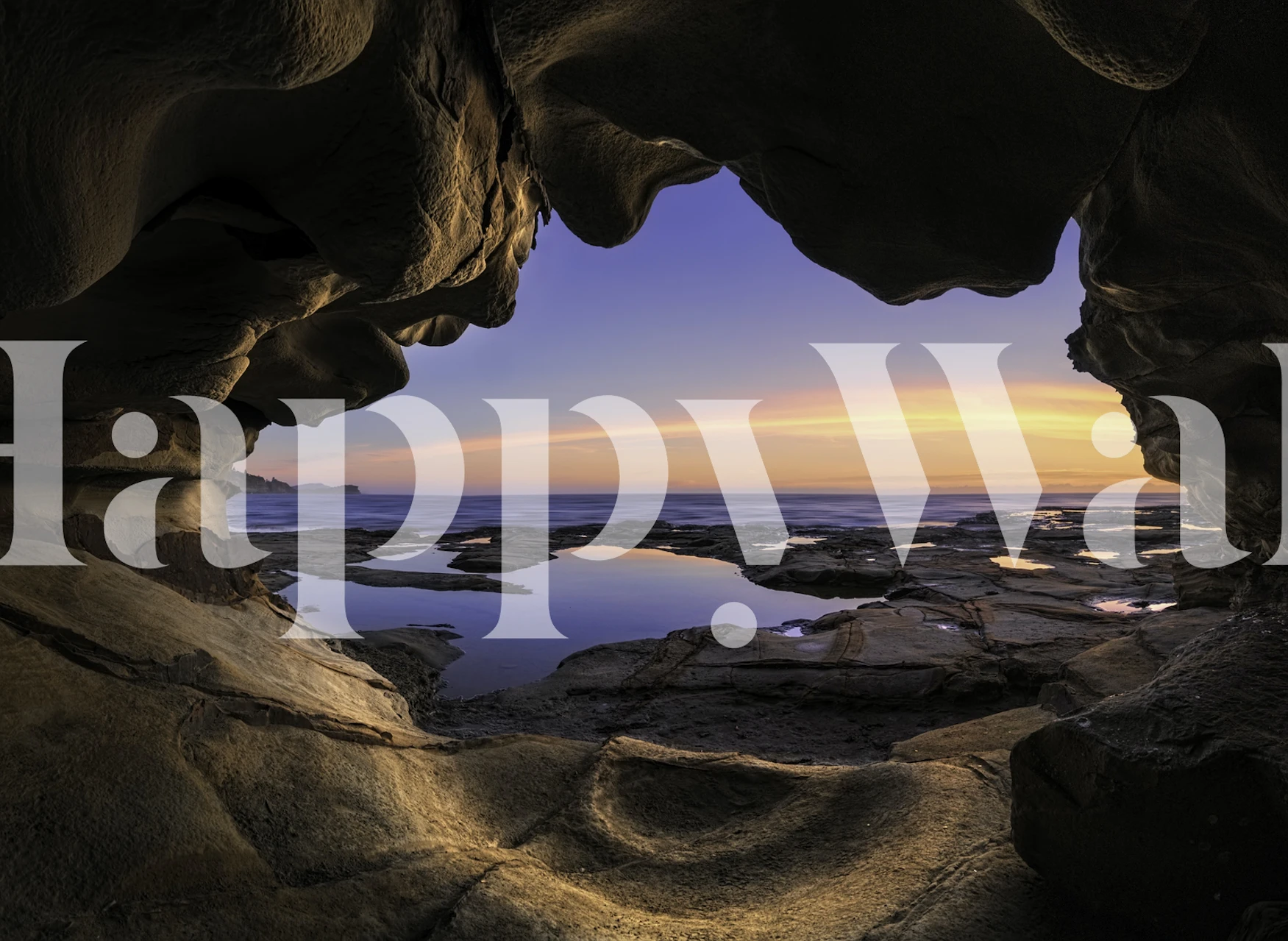Scenic ocean view from a cave with rocky textures wallpaper