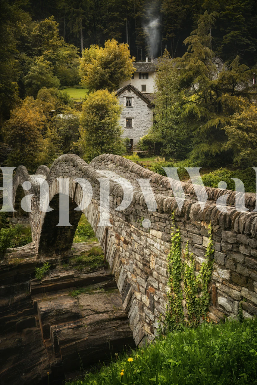 Rustic stone bridge surrounded by greenery and a mountain house wallpaper