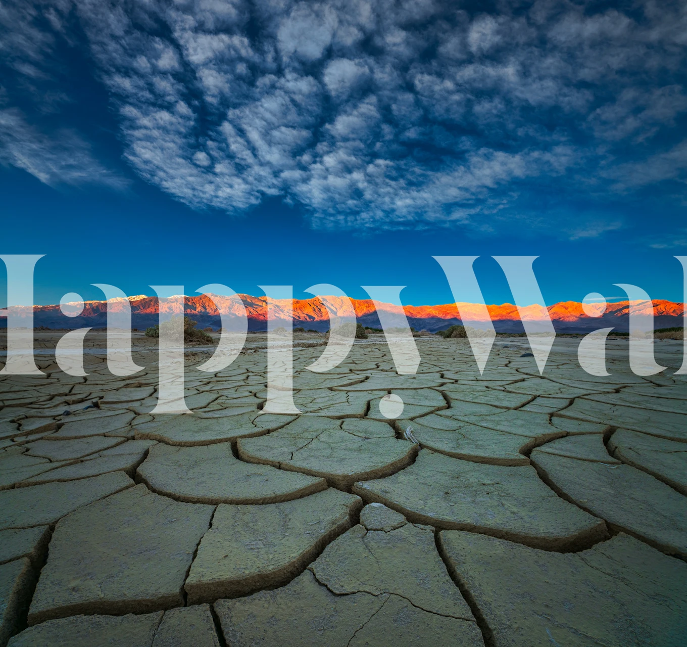 Desert landscape with cracked earth and blue sky wallpaper