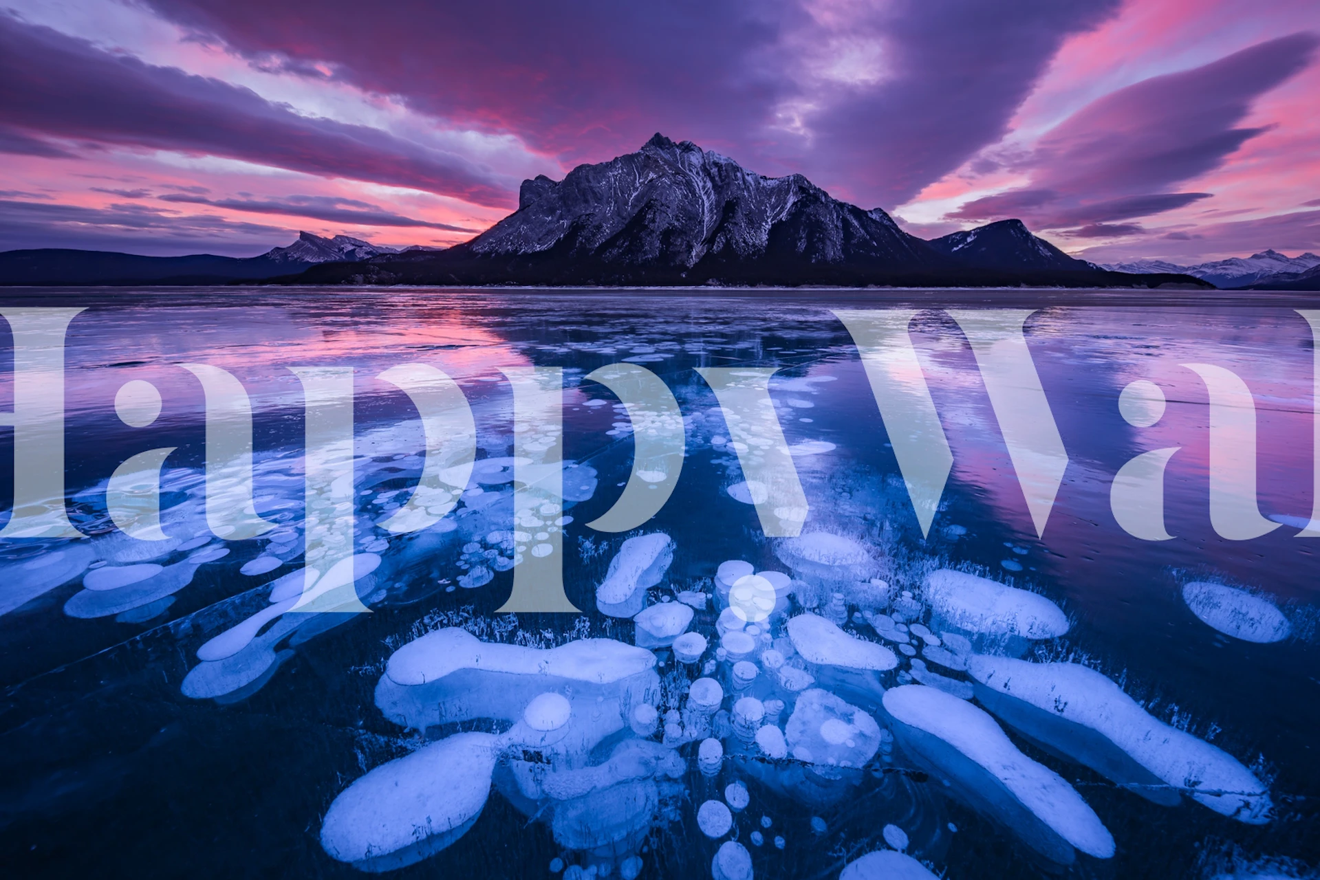 Purple mountain reflecting on icy lake wallpaper