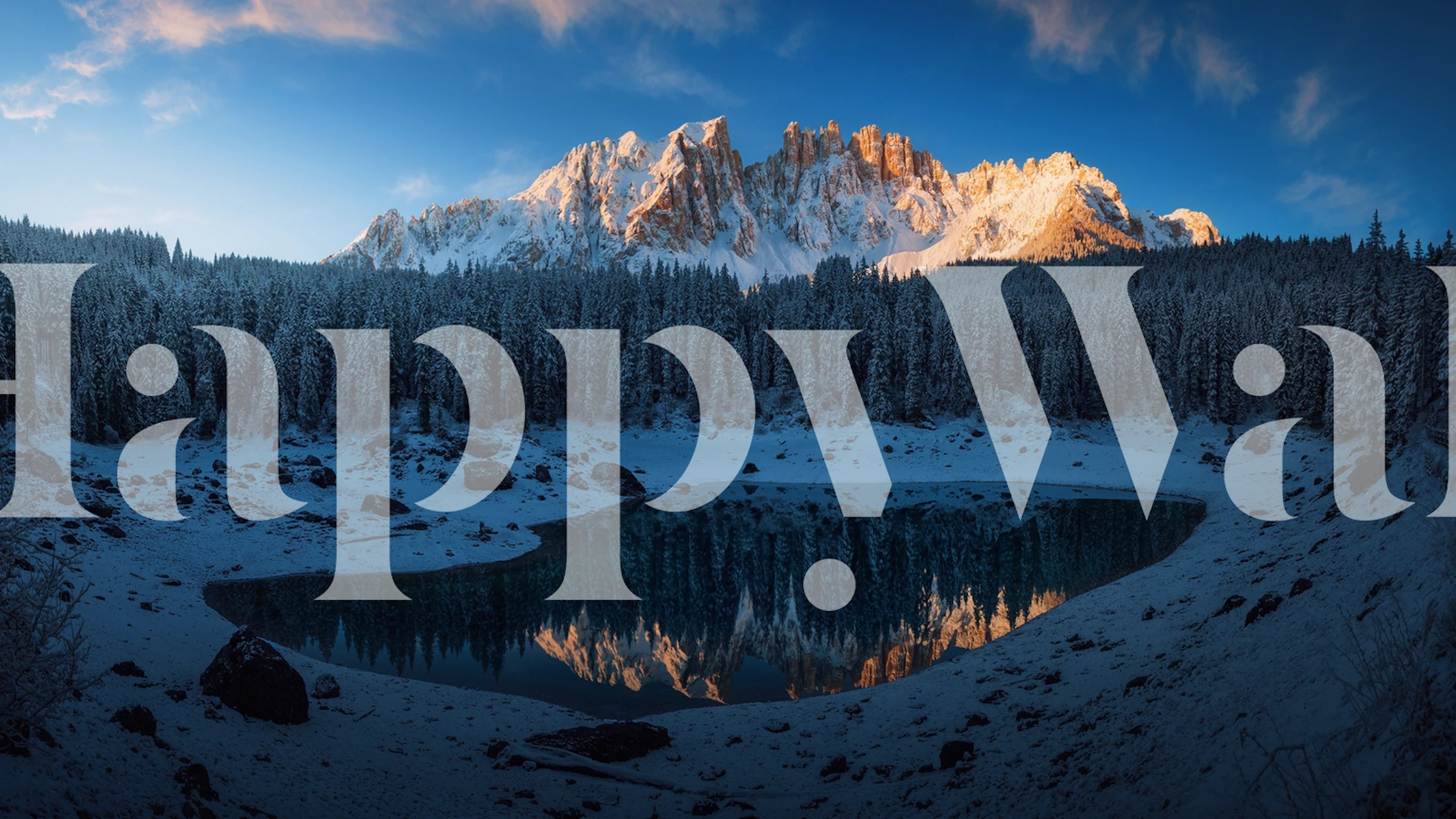 Scenic mountain reflection in lake surrounded by snow-capped trees wallpaper