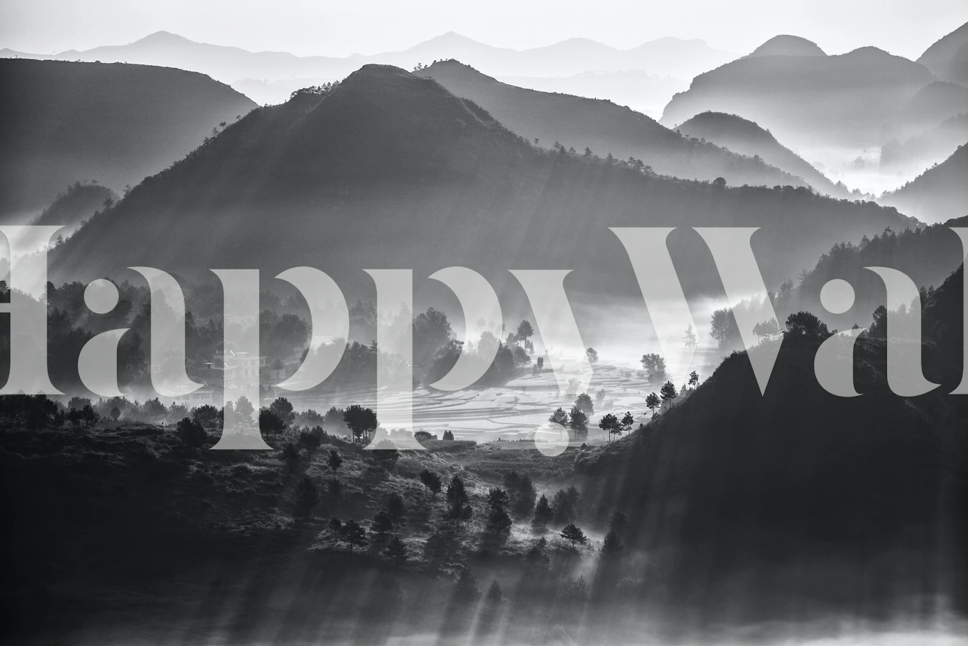 Monochrome wall mural featuring a layered landscape with misty clouds shrouding rolling hills.