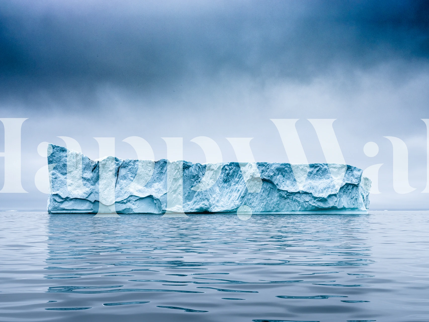 Iceberg floating in calm waters under a cloudy sky wallpaper