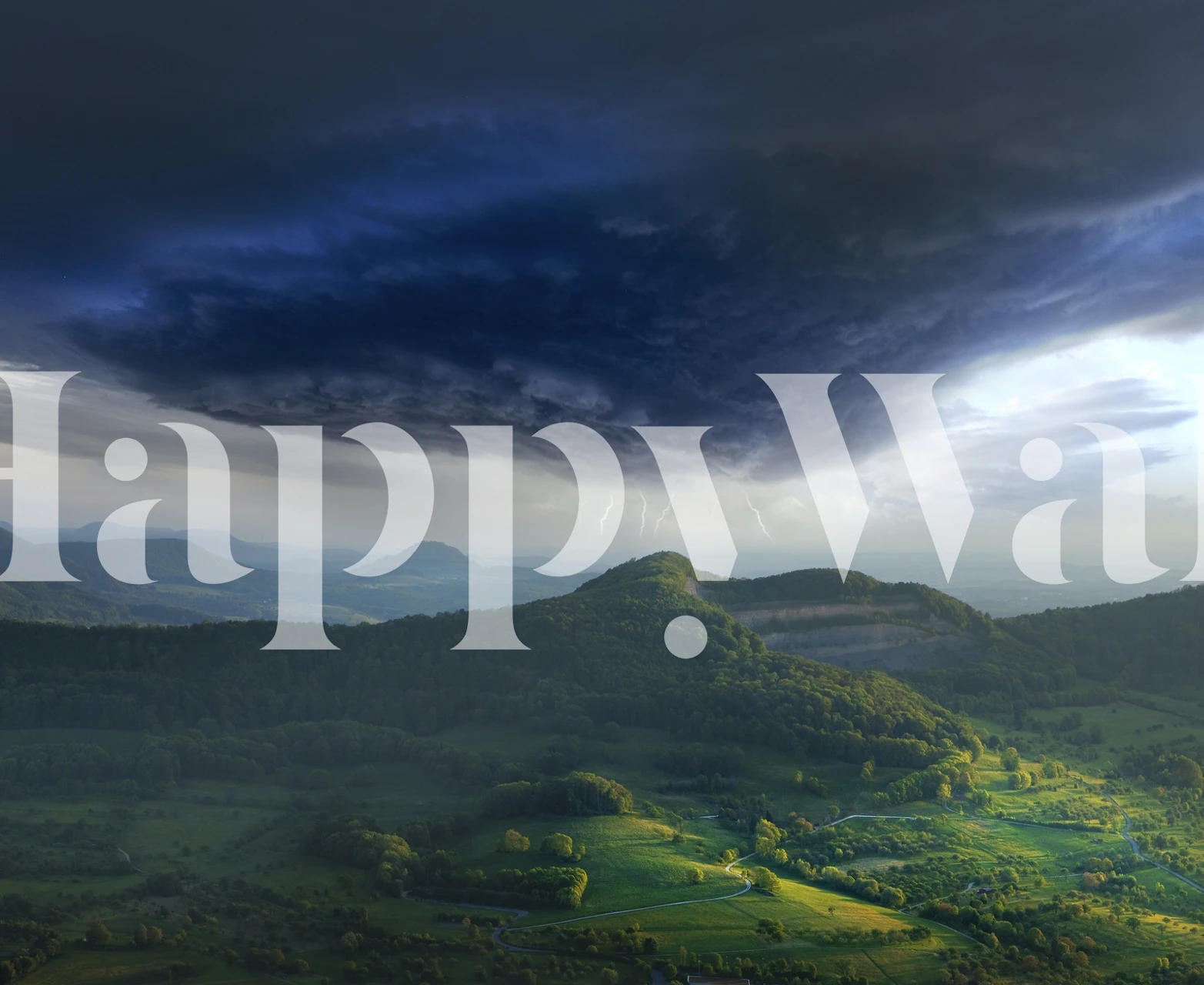 Scenic stormy landscape featuring dark clouds and green hills wallpaper