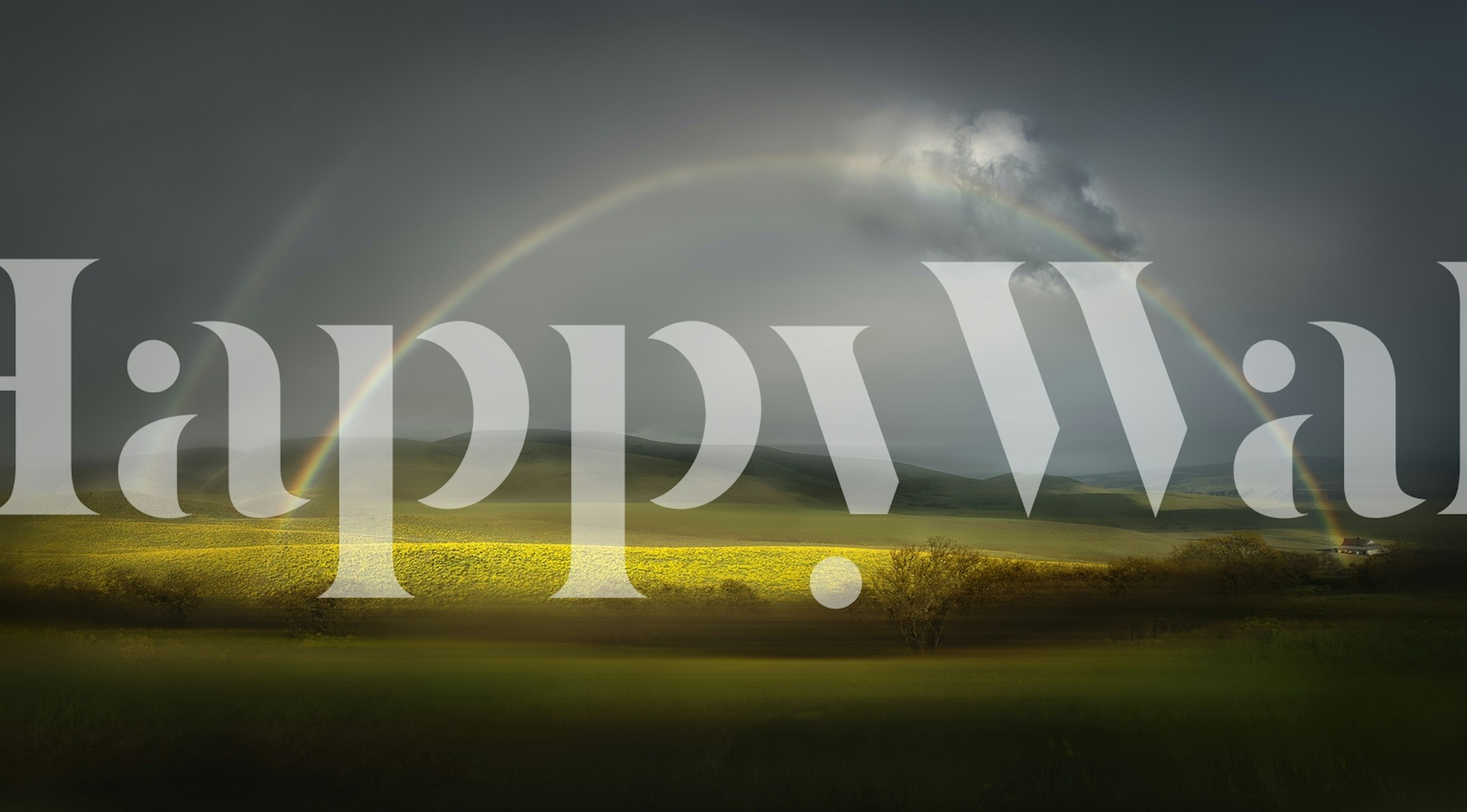 Rainbow over a tranquil landscape with fields and mountains wallpaper