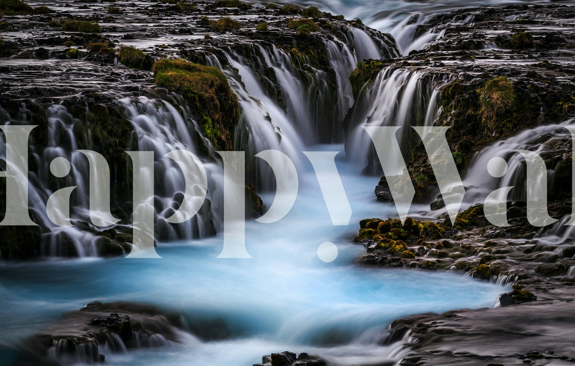 Blue waterfall scene with cascading water on dark rocks wallpaper