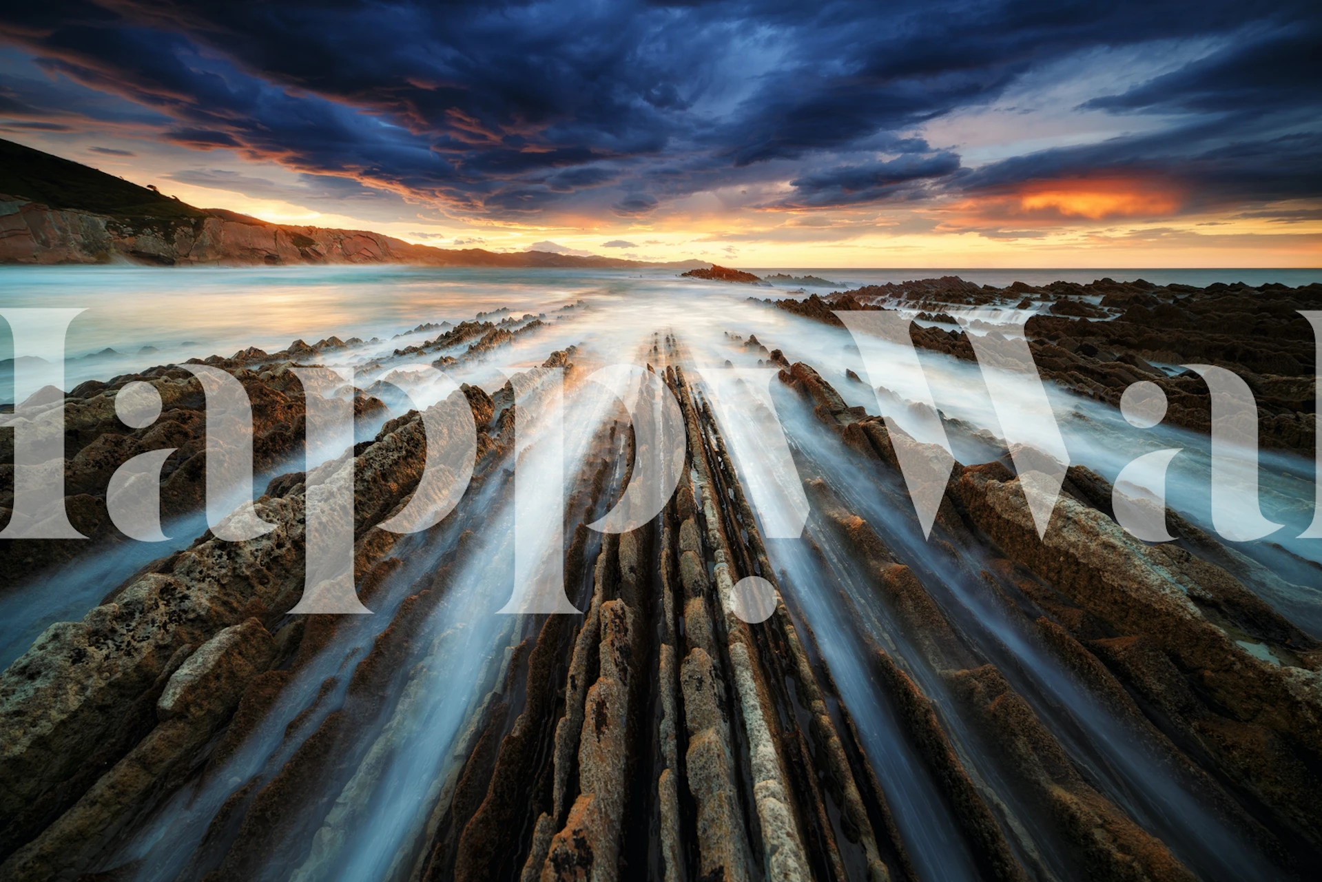 Zumaia Flysch wall mural depicting layered rock formations and ocean sunset
