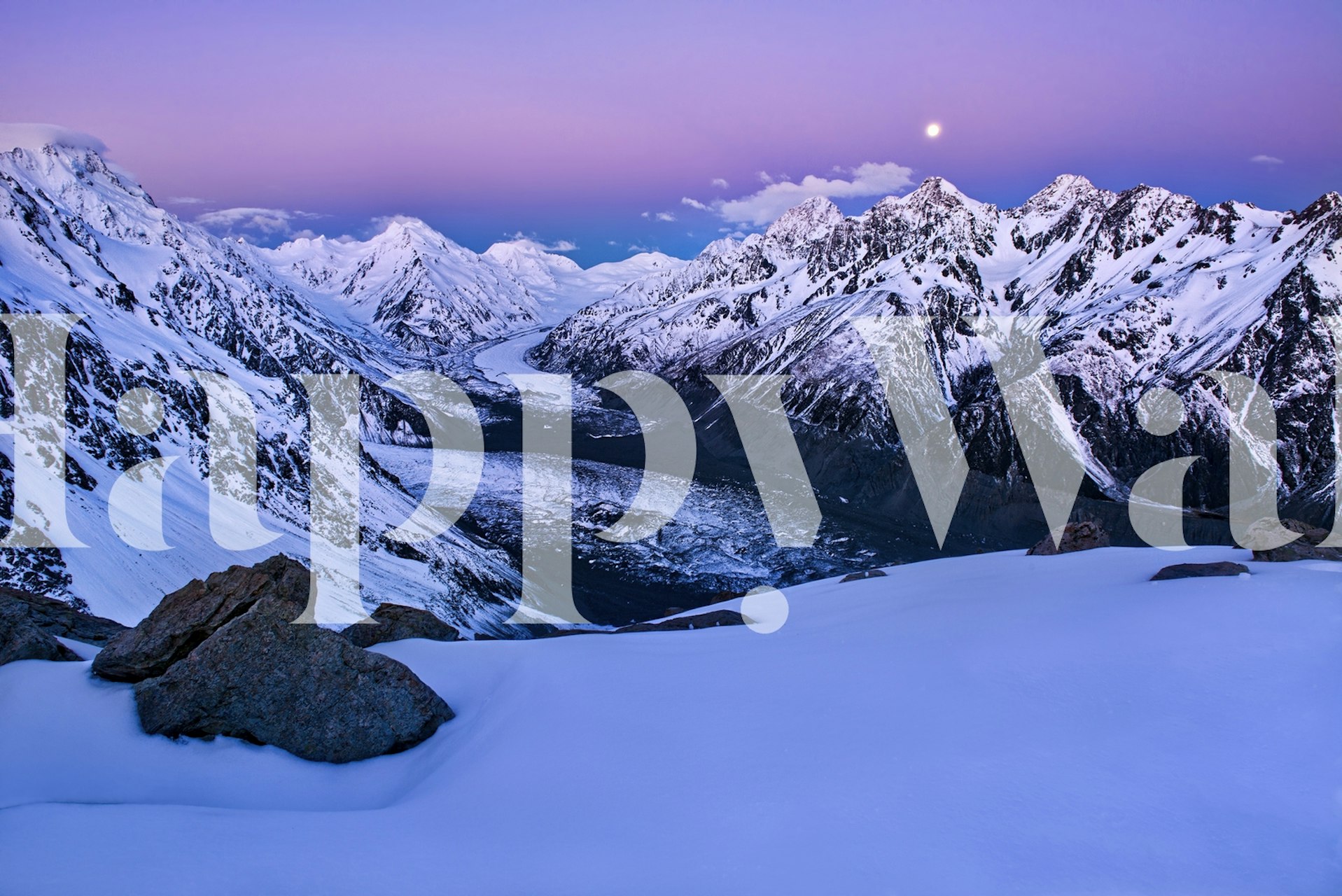 Snow-covered mountain peaks at twilight with a glowing moon wall mural