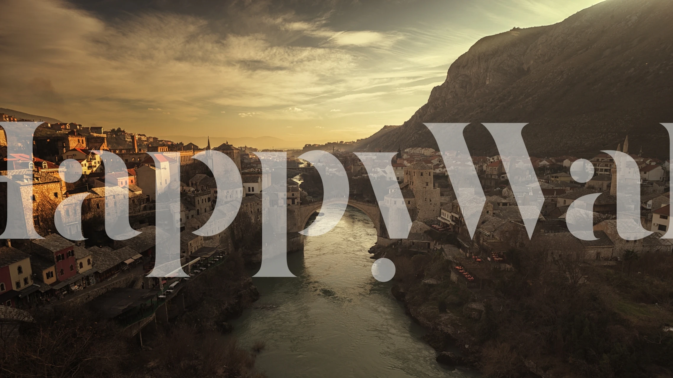 Mostar bridge and cityscape in warm tones wallpaper