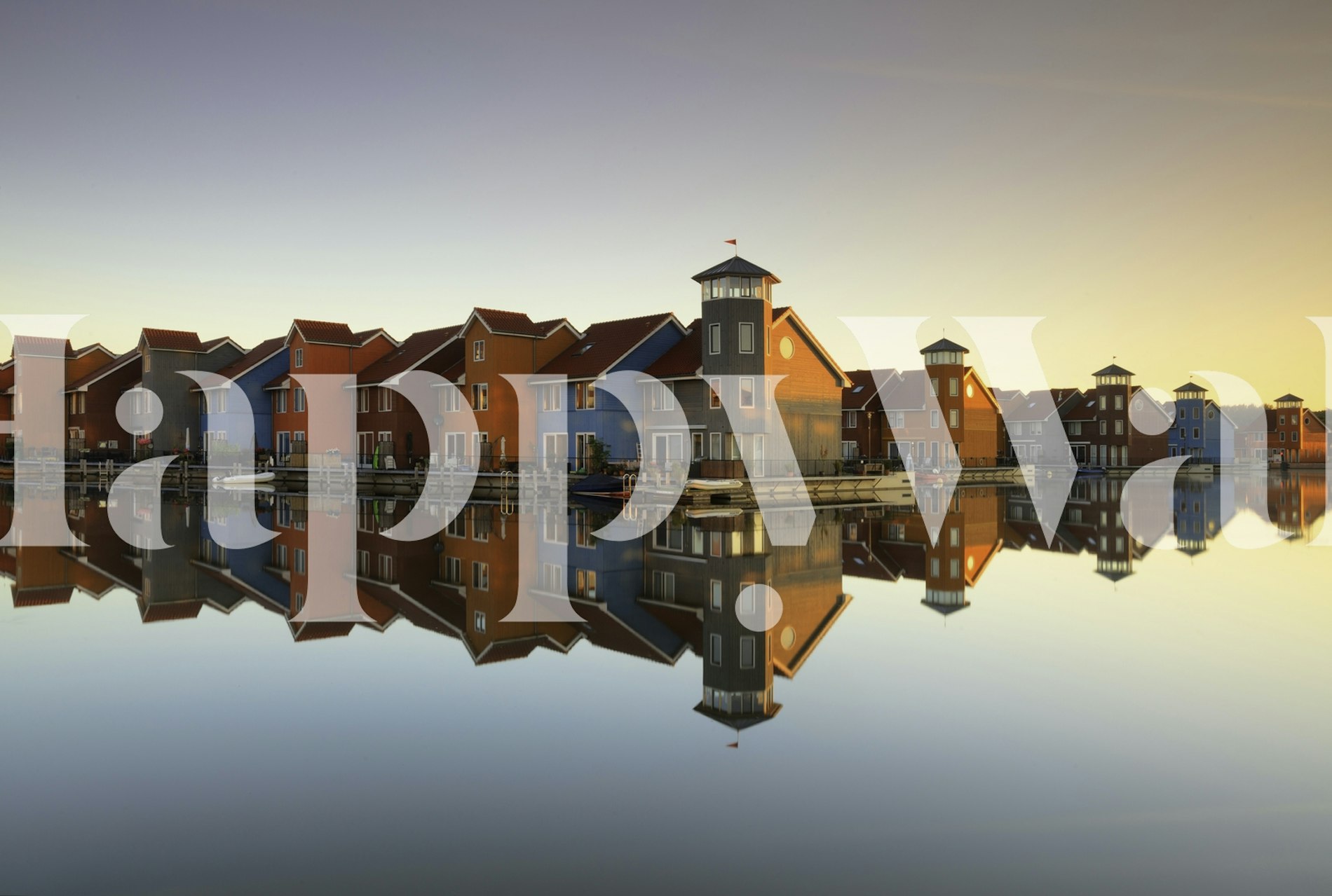 Colorful village houses reflecting on water wallpaper
