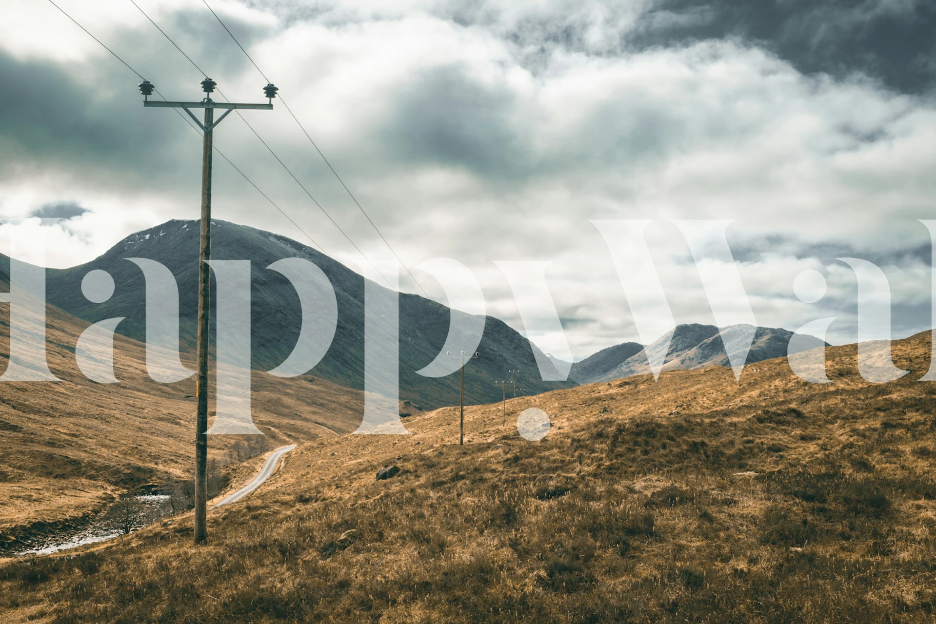 Winding road landscape in Scottish Highlands with gray clouds and mountains wallpaper