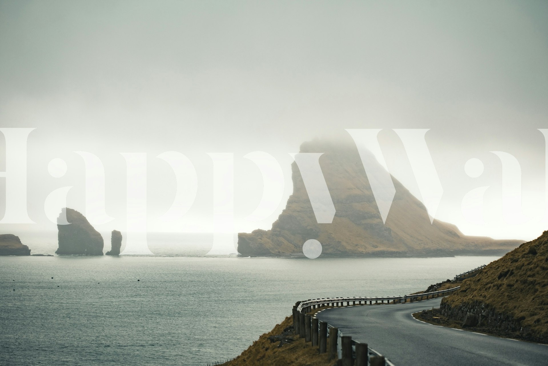 Coastal landscape with misty hills and rocky formations wallpaper