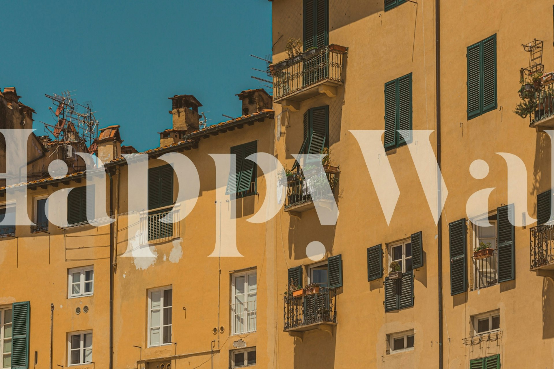 Yellow building with green shutters and balconies wallpaper