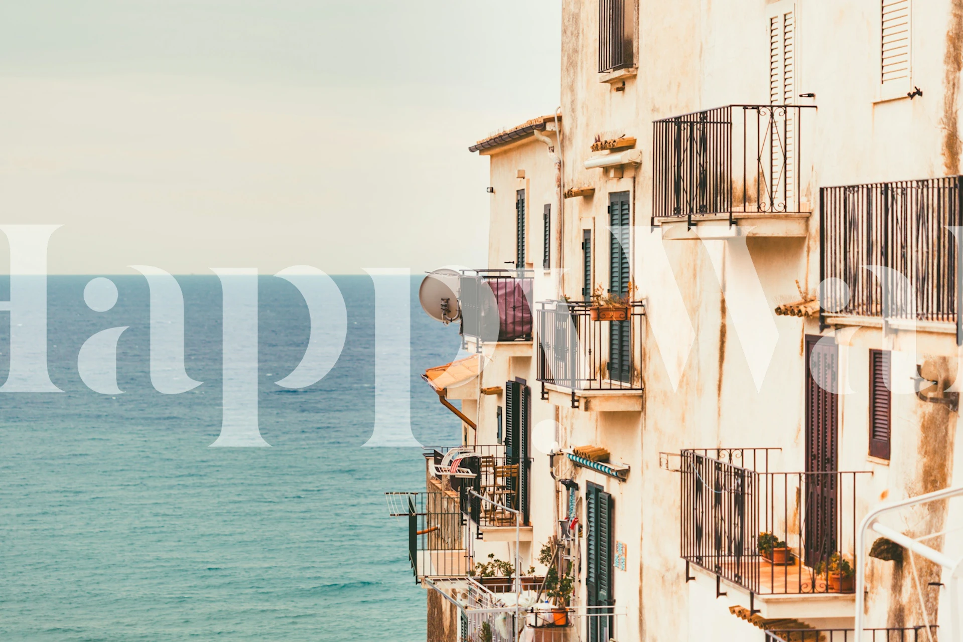 Seaside balconies overlooking blue ocean view wallpaper