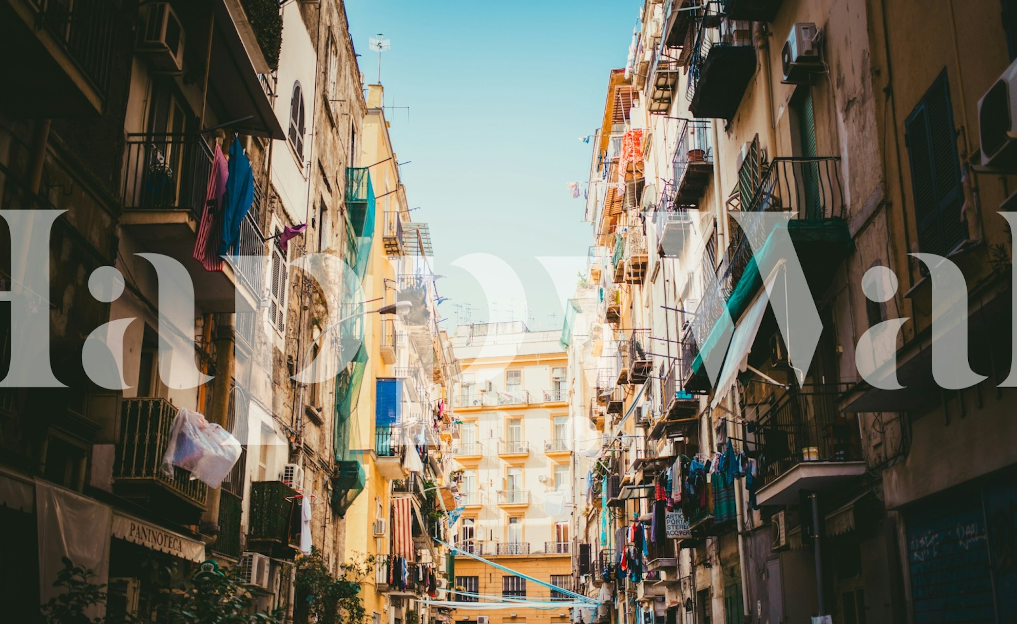 Napoli city facade with colorful buildings and laundry wallpaper