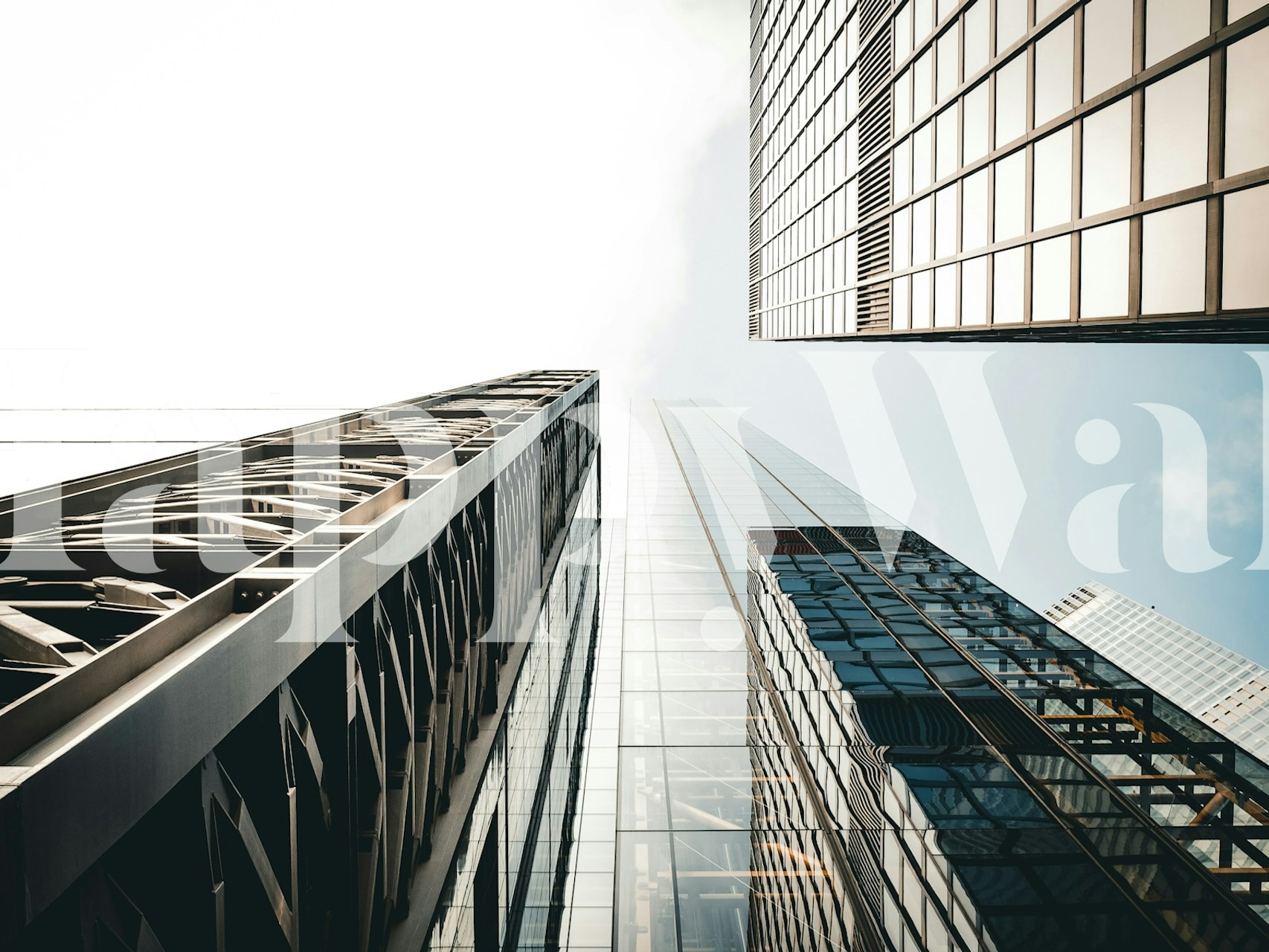 City skyline with reflective glass buildings and blue sky wallpaper