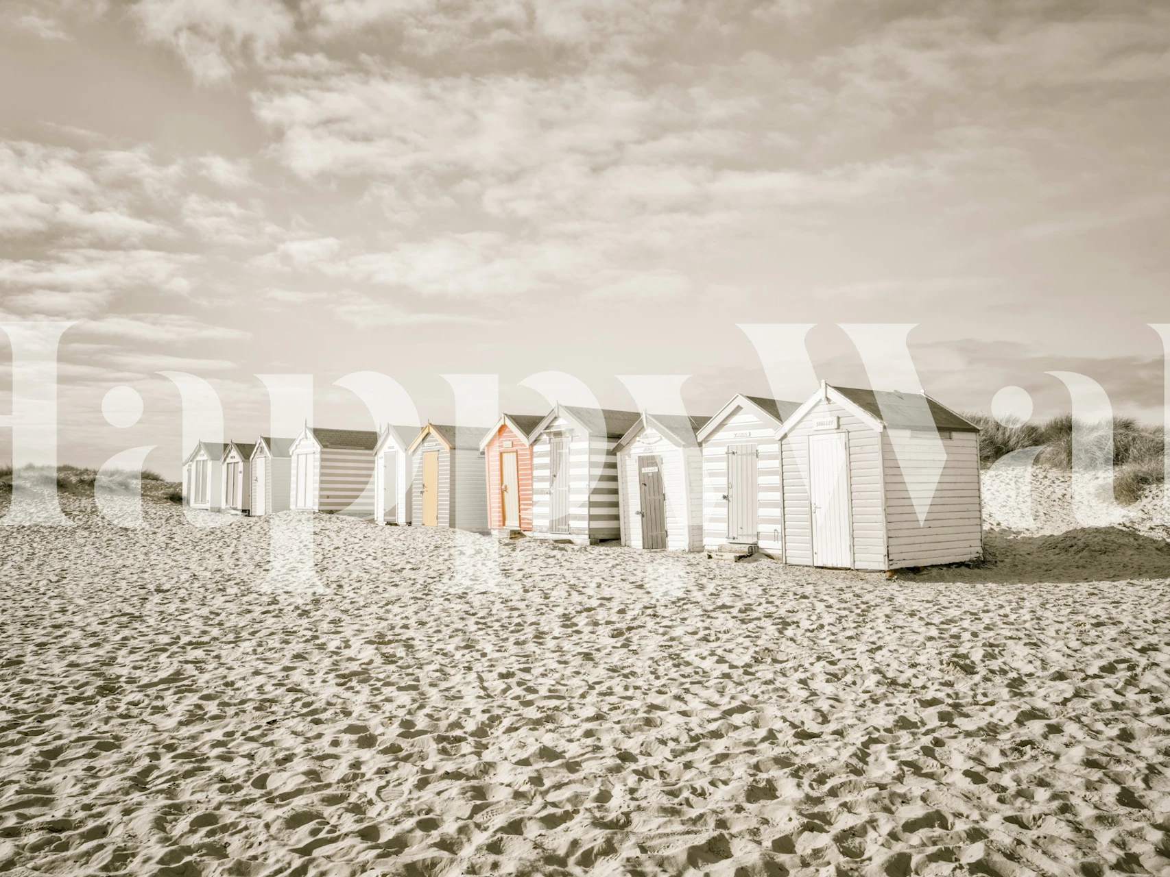 Beach huts in pastel colors on sandy shore wallpaper