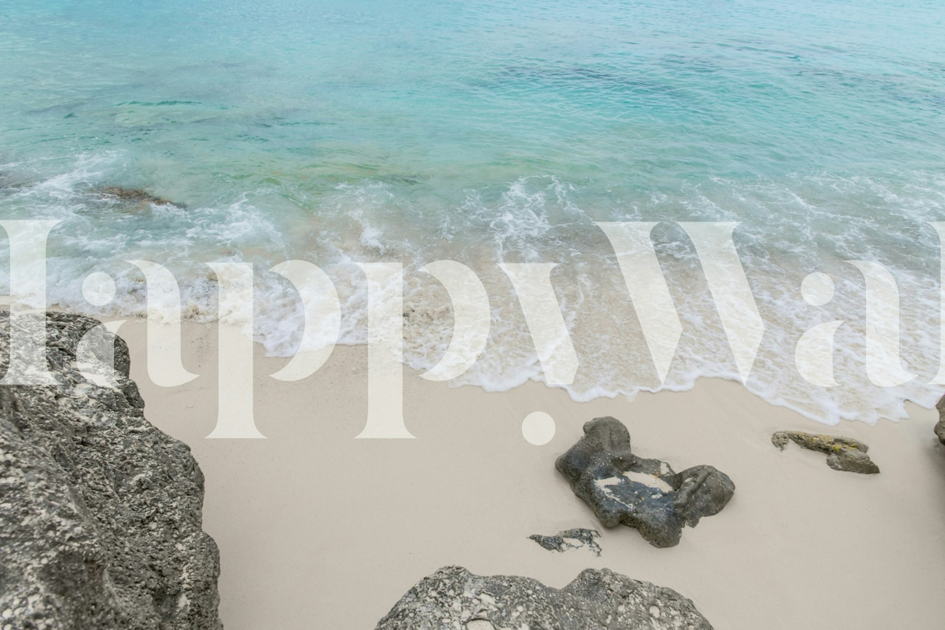 Ocean waves meeting sandy beach with rocks wallpaper