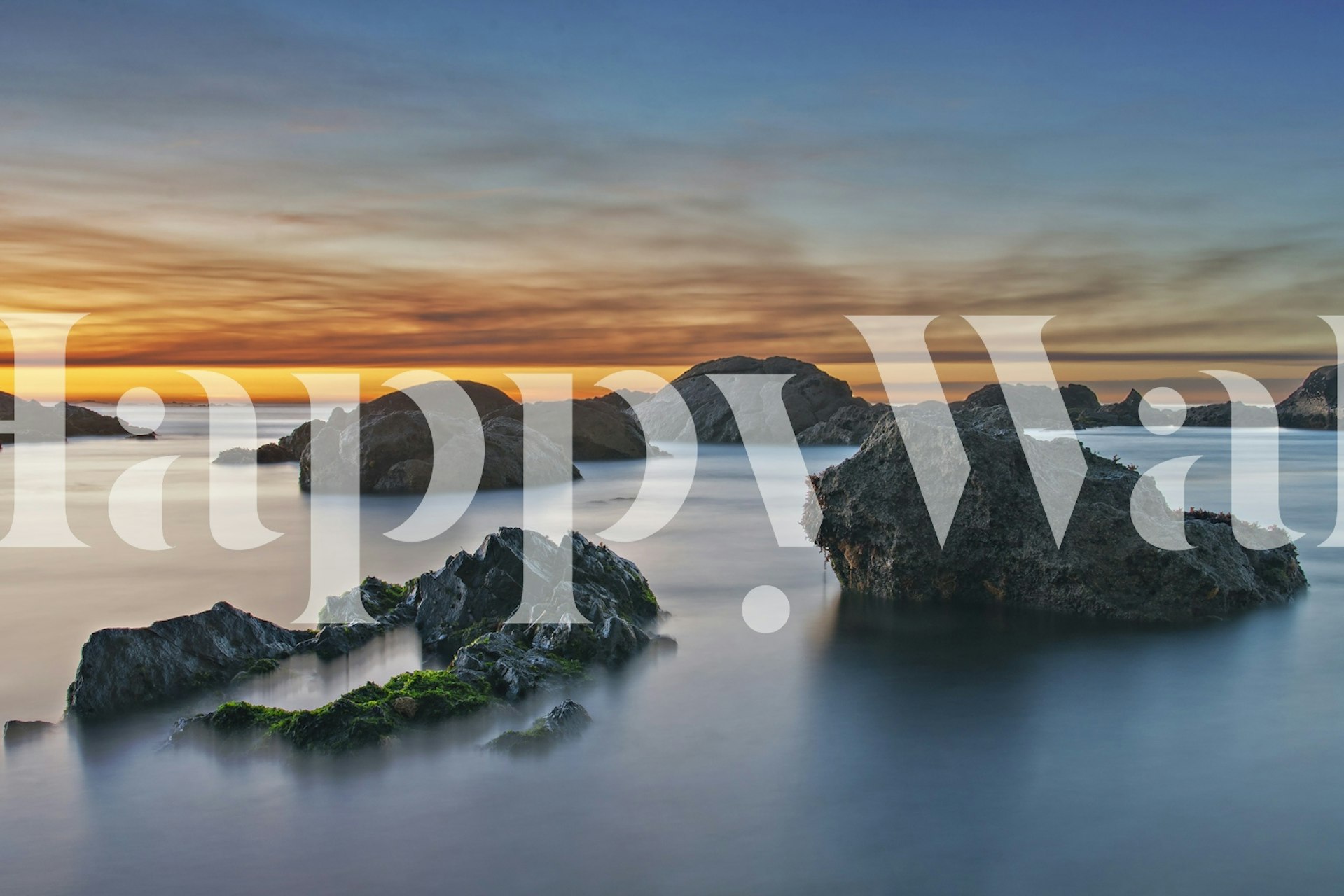 Coastal landscape with sunset hues and sea rocks wallpaper