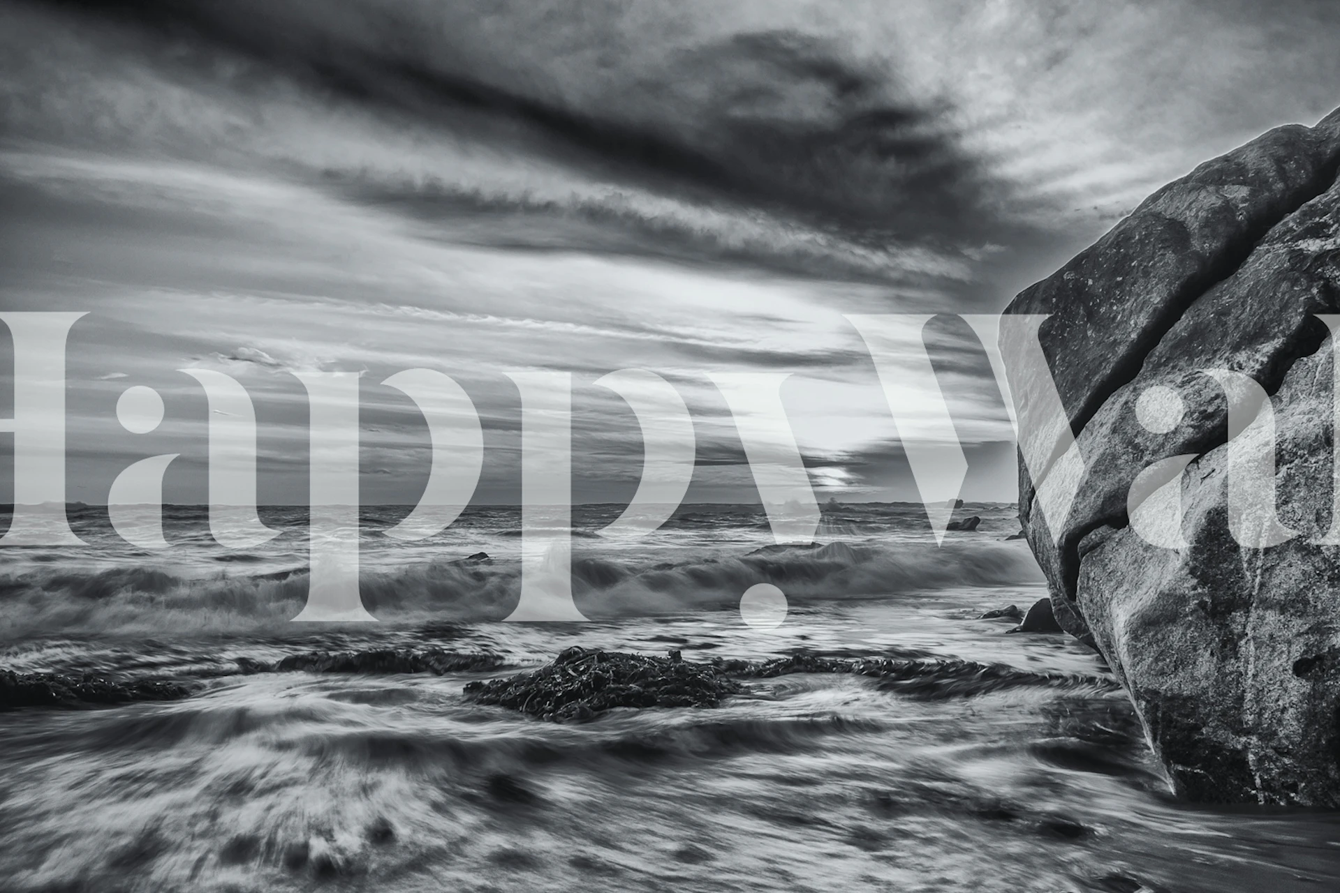 Black and white coastal wall mural depicting waves and rocks