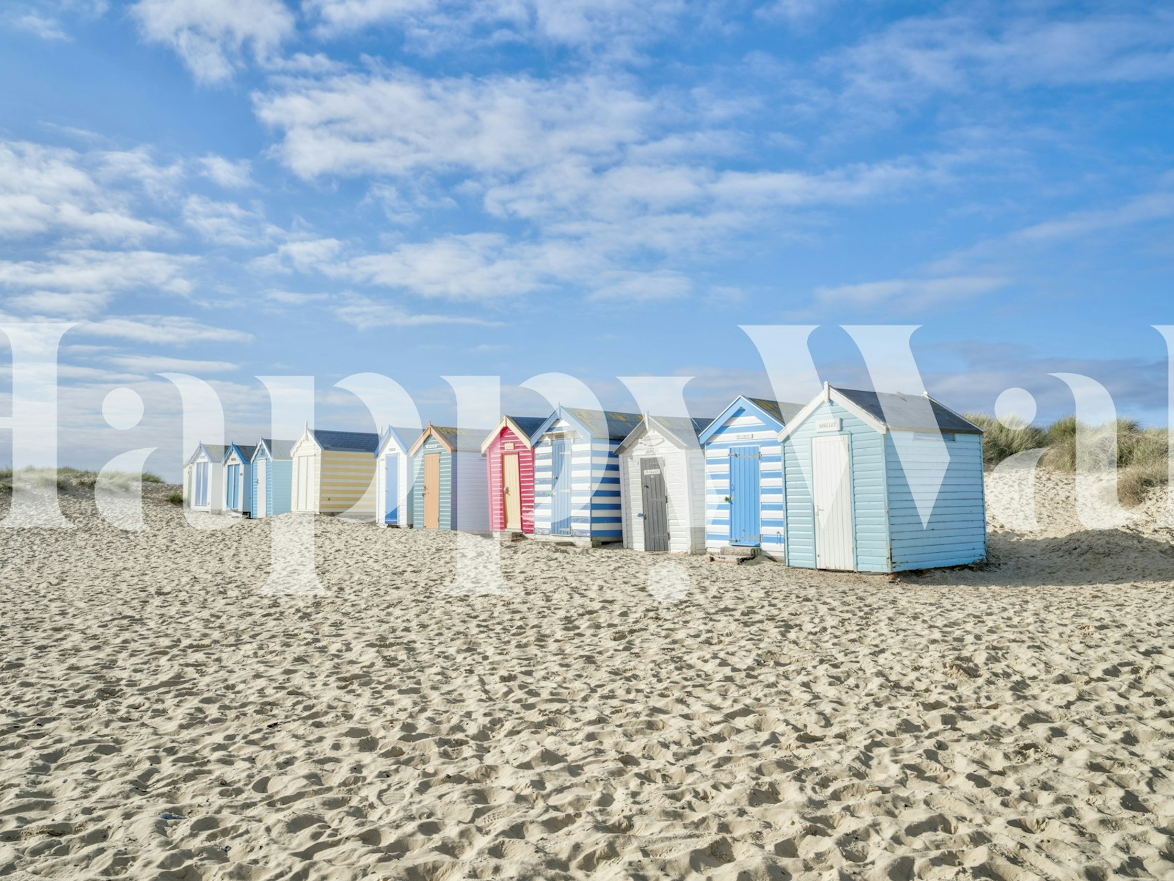 Vibrant coastal sheds wallpaper in a room