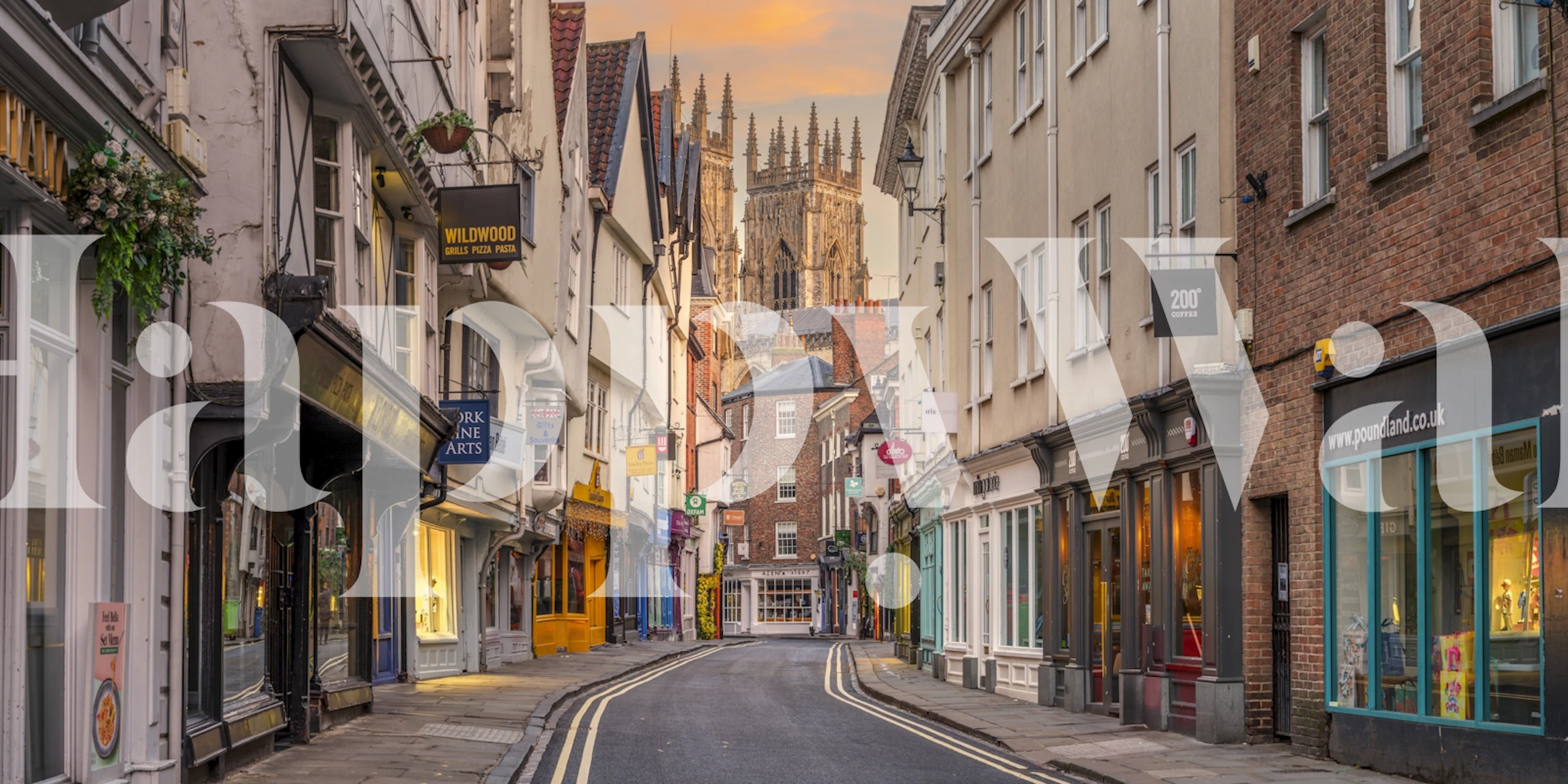 Historic townscape at twilight with shops and church spires wallpaper