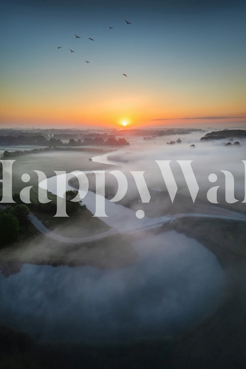 Sunrise over winding river wallpaper in a room