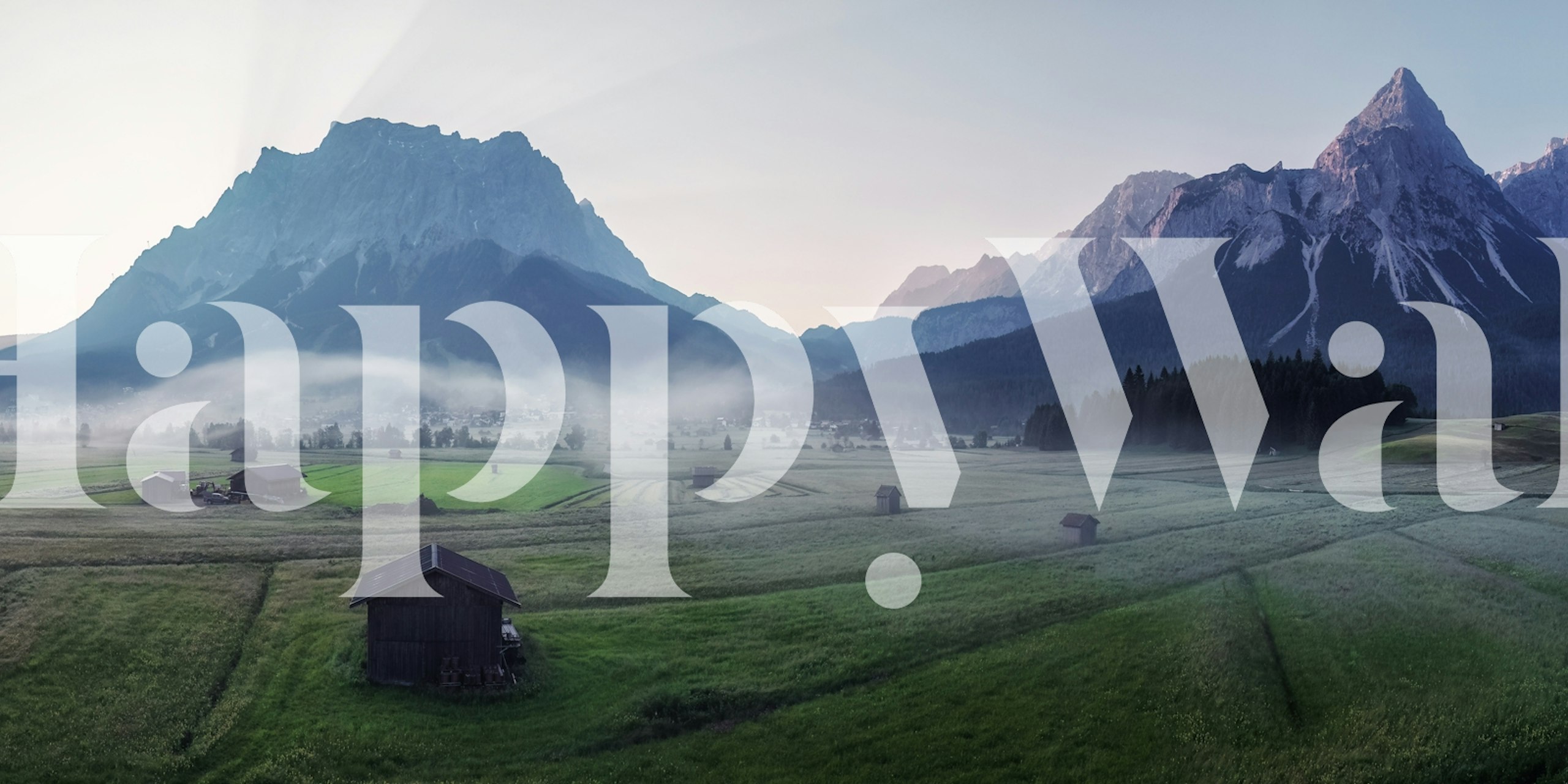 Mountain landscape with soft green fields and misty hills wallpaper