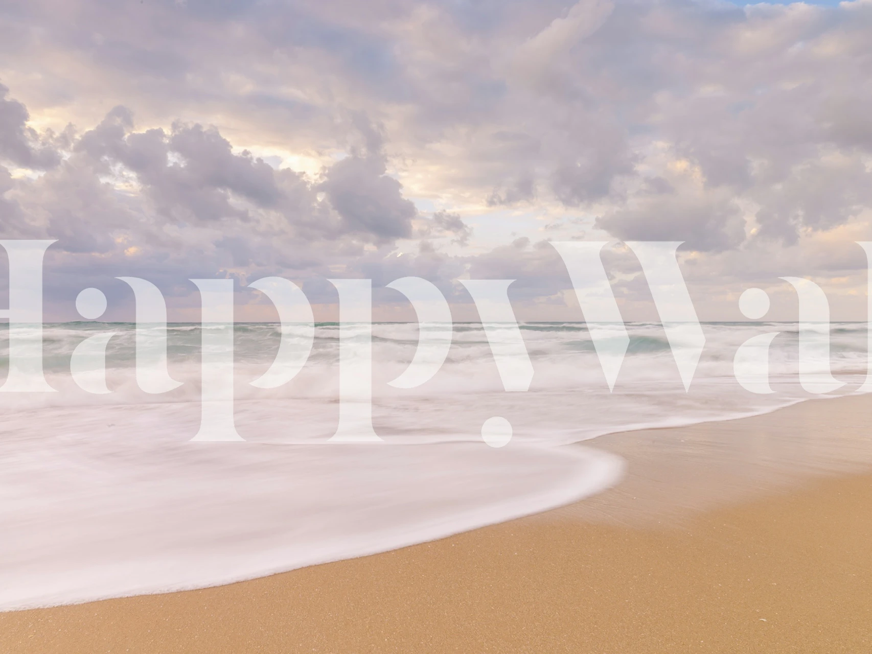 Ocean waves hitting sandy shore under cloudy sky wallpaper