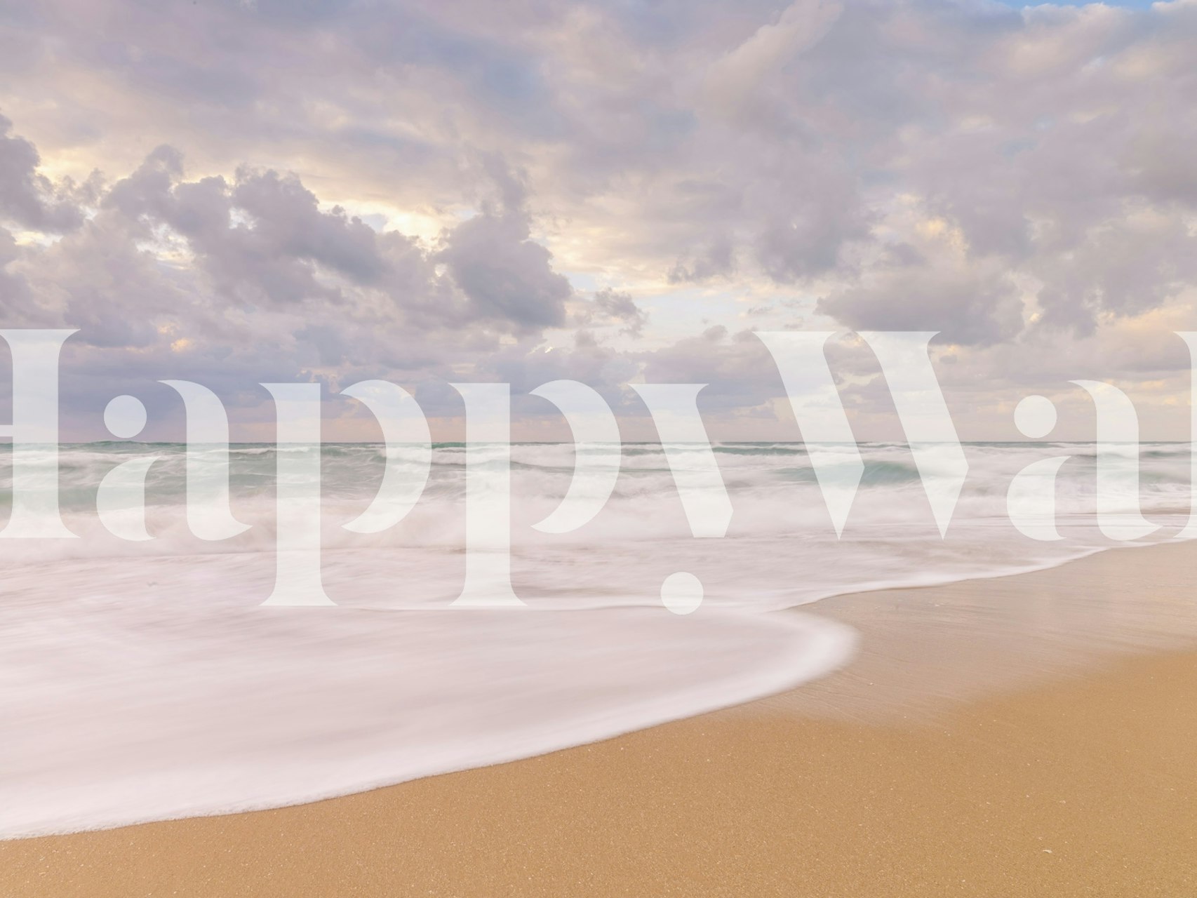 Ocean waves hitting sandy shore under cloudy sky wallpaper