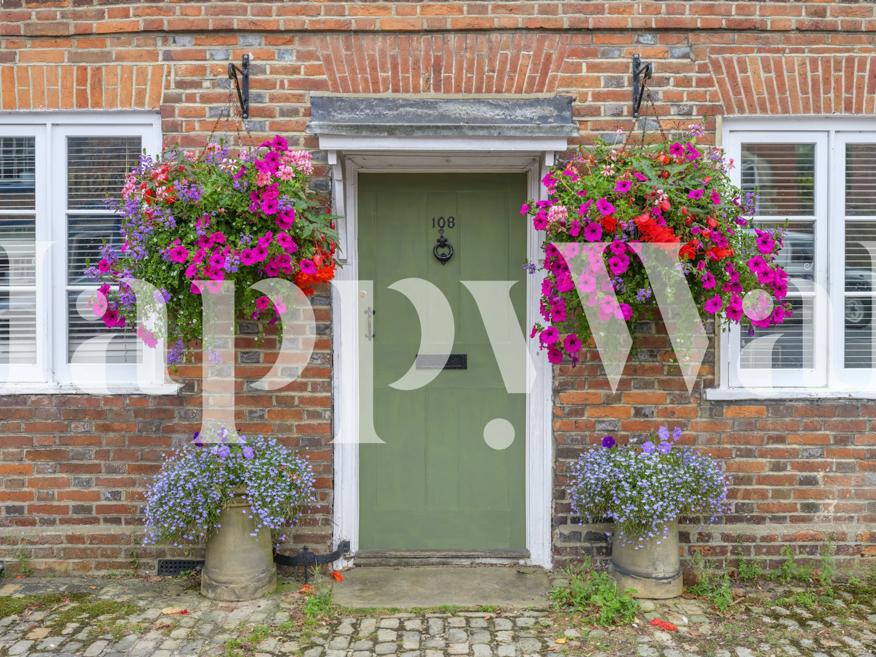 Floral wallpaper featuring a green door, vibrant flowers, and brick walls