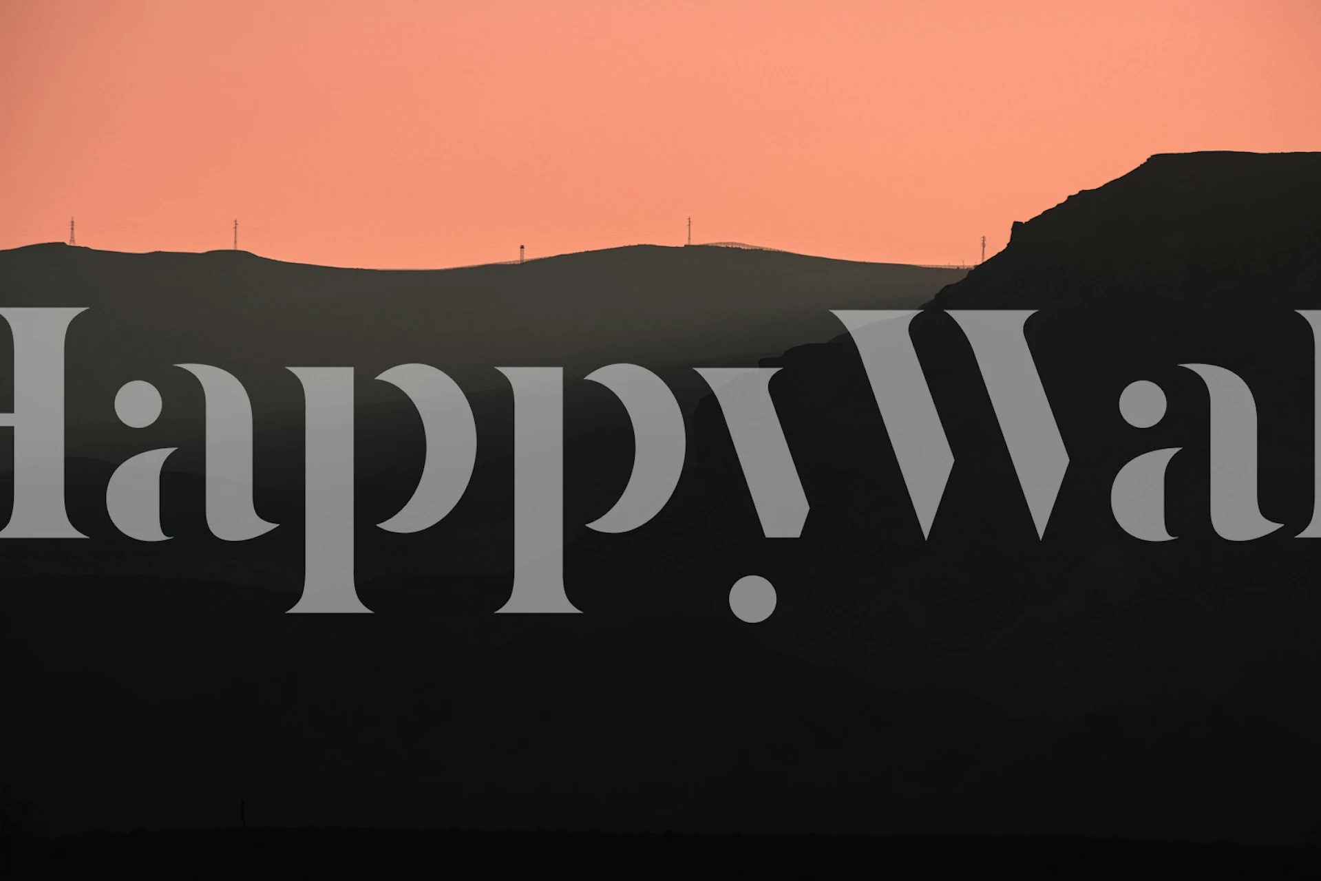 Black silhouette of mountains against a pink sunset wallpaper